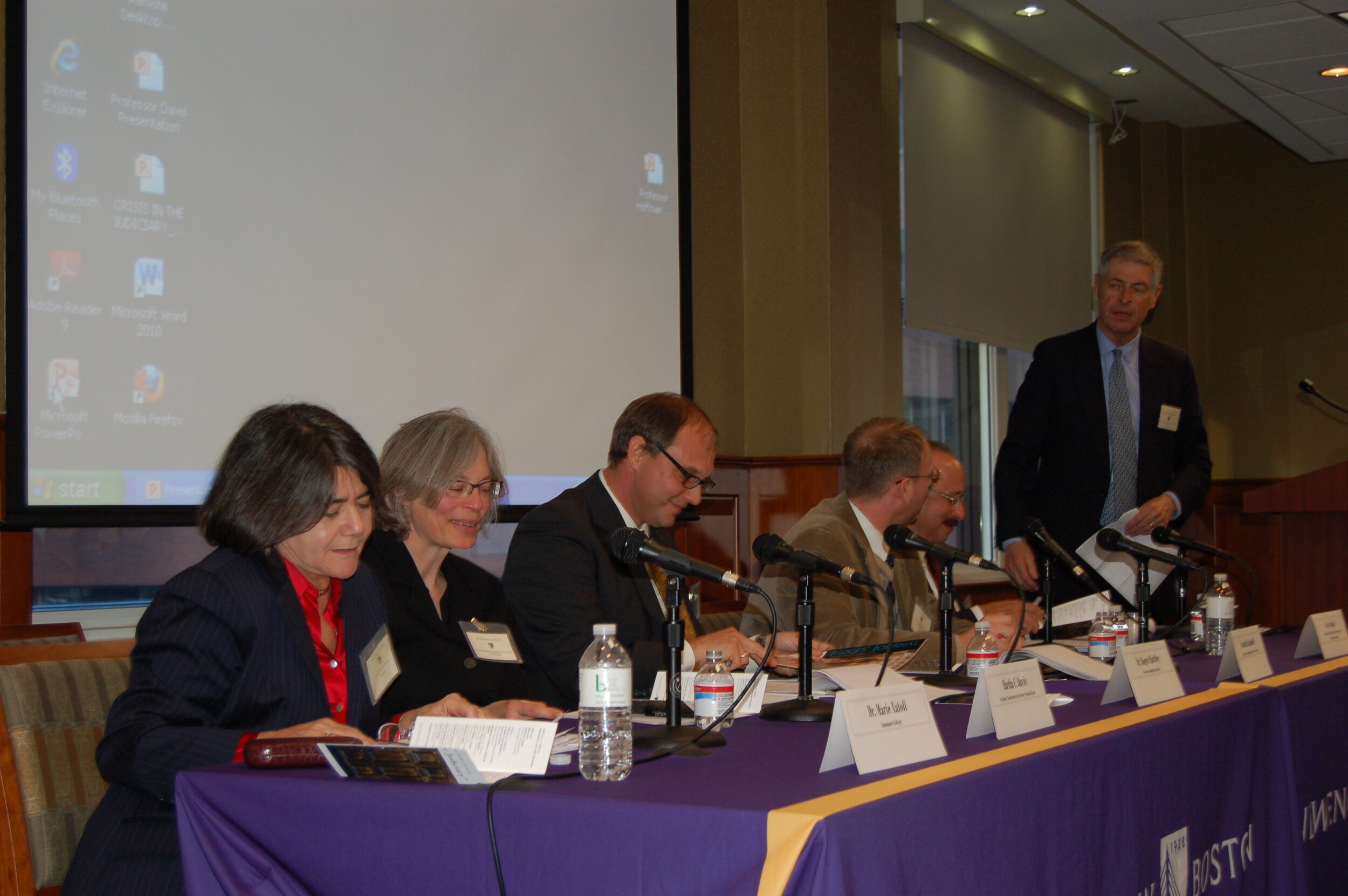  Hon. William Cowin moderates. Seated left to right, Prof. Marie Natoli, Prof. Martha Davis, Dr. Roger Hartley, Prof. Donald Cambpell, and Lee Suskin. 