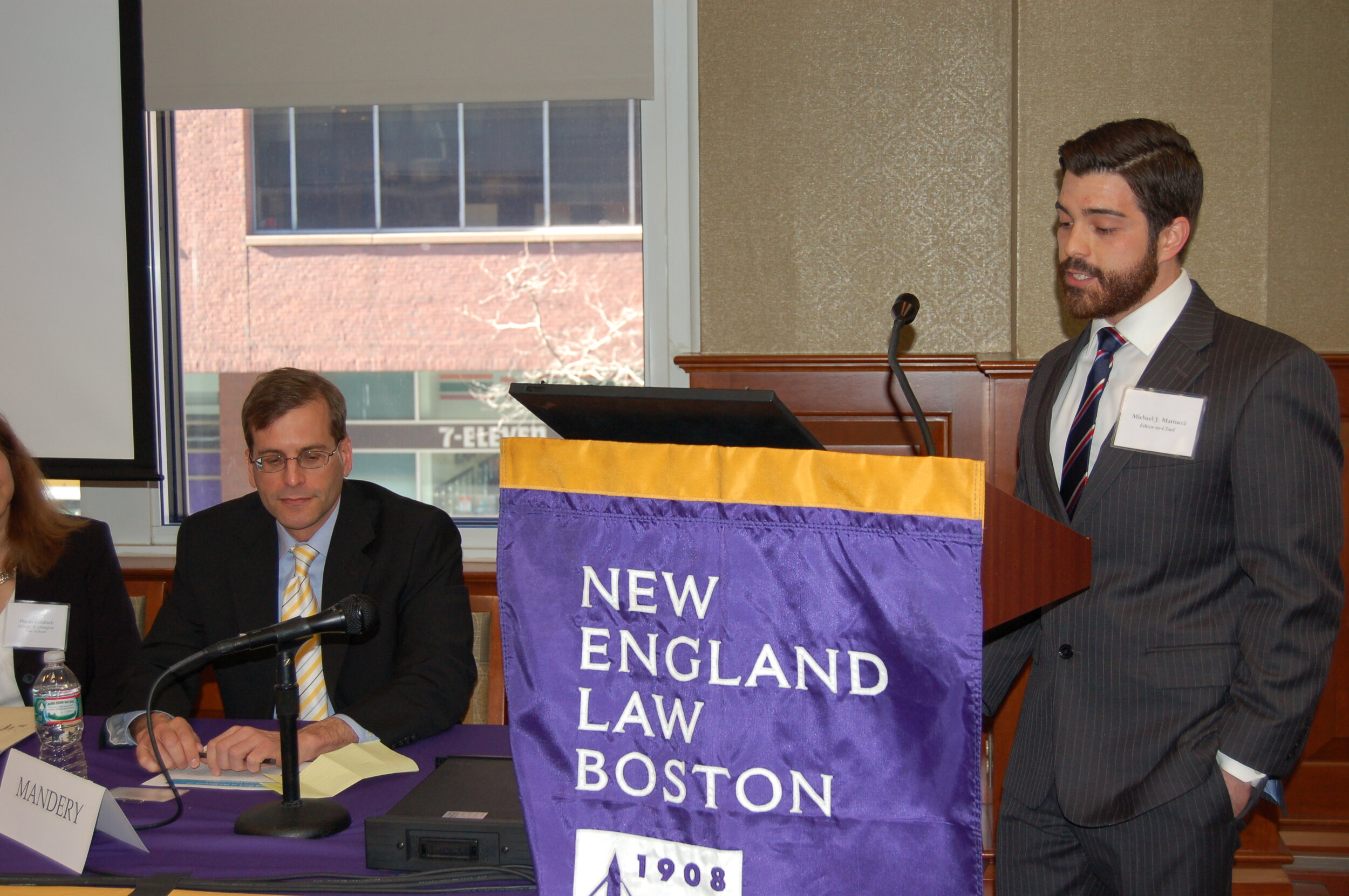  Editor-in-Chief Michael Martucci introduces Professor Evan J. Mandery, who looks on. 
