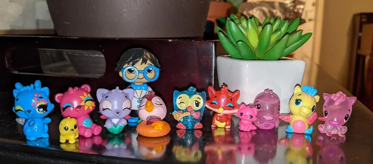 Gratitude Practice 2020 Day 281: Tiny plastic glitter-tastic girl gang combo creatures and a strange creeper rocking bright blue glasses lurking in the back.