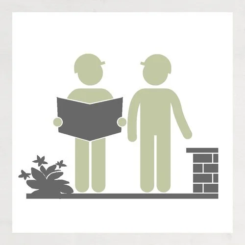 Silhouette of two children, one reading a book, outdoors with a small plant and a brick wall.