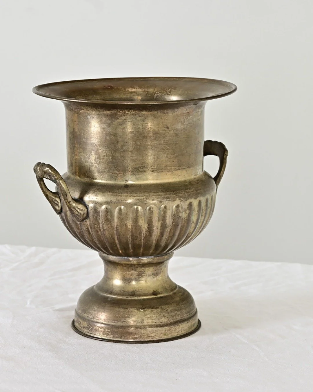 French Vintage Brass Champagne Bucket that will quickly become an indispensable serving piece for many entertaining needs; from chilling bottles to holding floral arrangements or greenery!
.
Classic urn form is reeded &amp; decorated with two small h