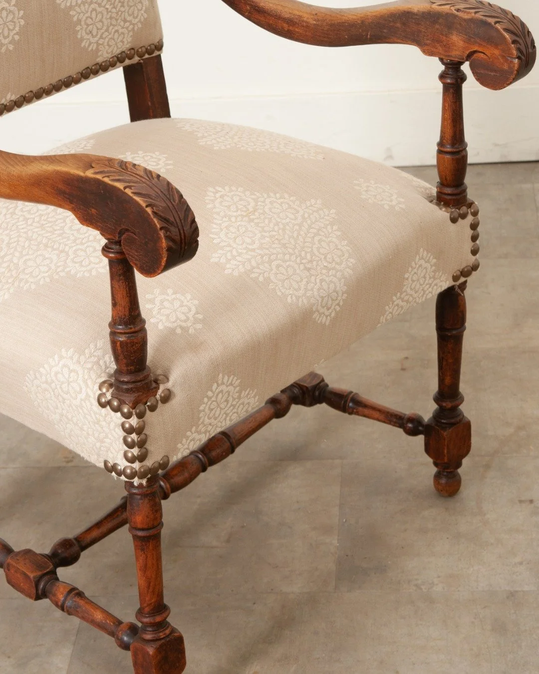 French 19th Century Walnut &amp; Upholstered Fauteuil in wonderful antique condition. The frame is tight &amp; has recently been upholstered in patterned fabric with nailhead trim. 
.
Versatile carved chair is quite comfortable with scrolling arms &a