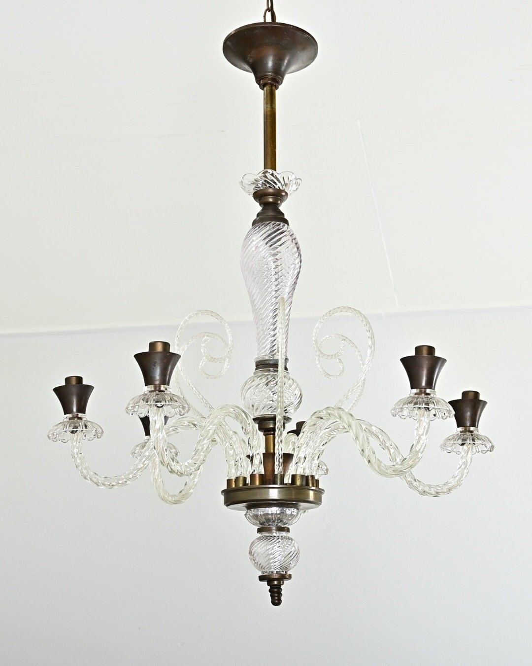 Vintage Italian Murano Glass Chandelier from Italy, midcentury circa 1940, in the style of Barovier &amp; Toso. Descending from a bronze-tone stem, the glass column swells &amp; narrows toward the delicate scrolls rising from six glass arms using a t