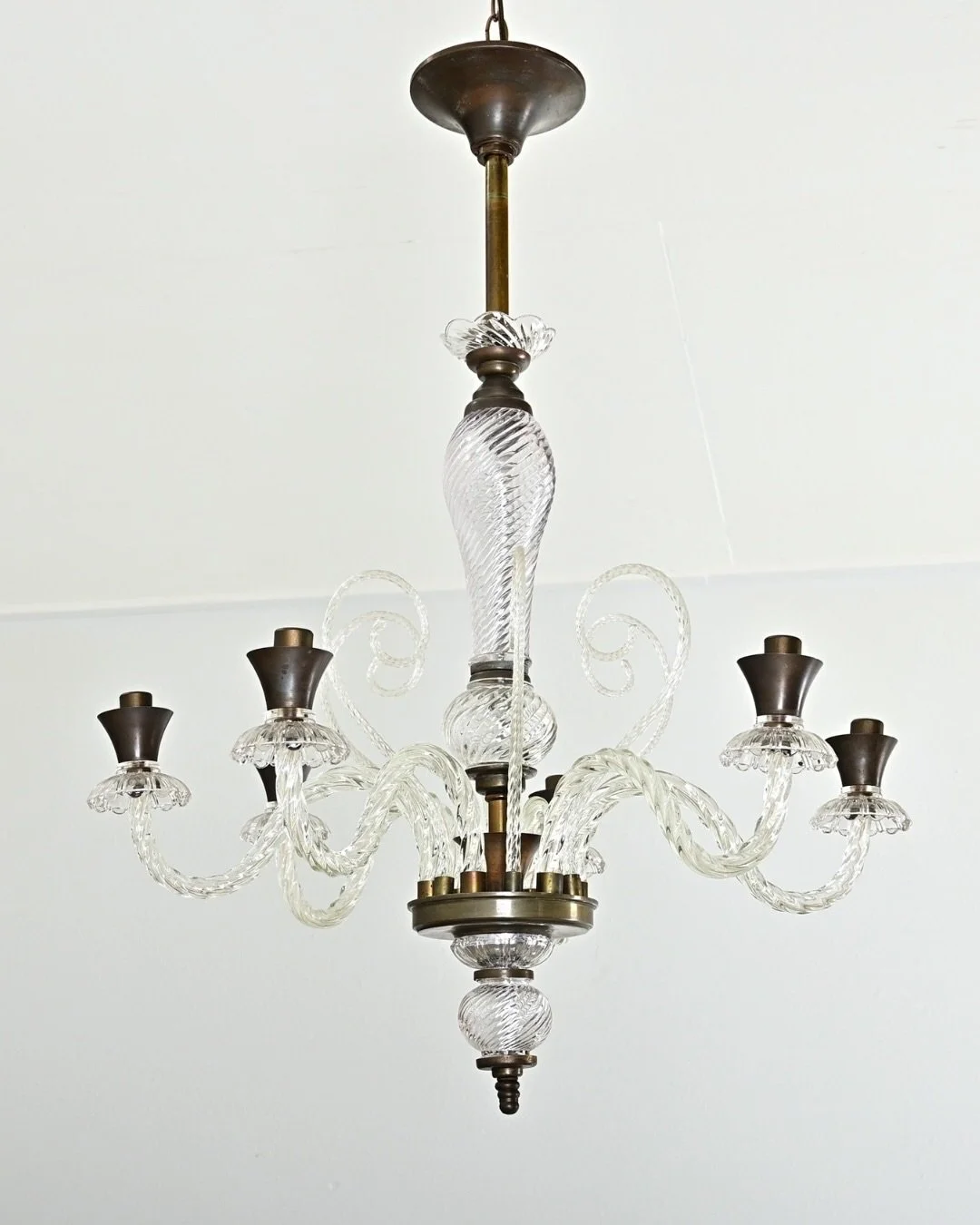 Vintage Italian Murano Glass Chandelier from Italy, midcentury circa 1940, in the style of Barovier &amp; Toso. Descending from a bronze-tone stem, the glass column swells &amp; narrows toward the delicate scrolls rising from six glass arms using a t