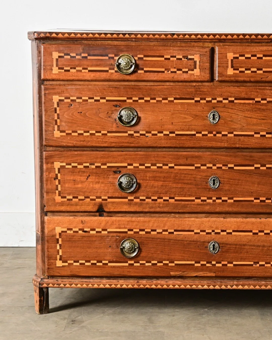 Extraordinary Italian 19th Century Inlay Commode, Neoclassical in style, decorated with a graphic marquetry of dark &amp; light woods that creates definition around both sides &amp; front of the exterior. Beautiful top uses two planks shaped to chamf