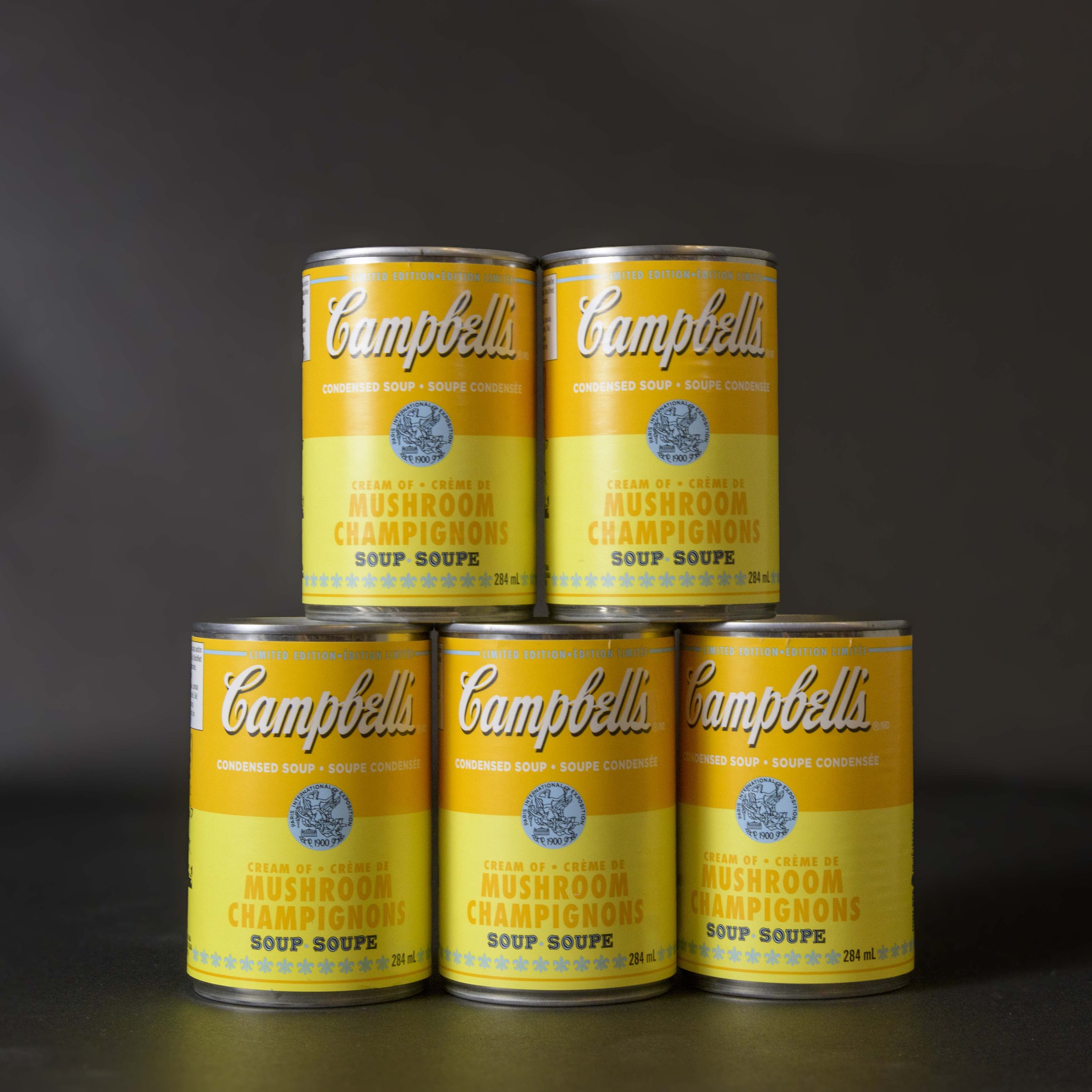 Styled product photo of limited-edition Campbell's mushroom soup cans – e-commerce photography with black backdrop