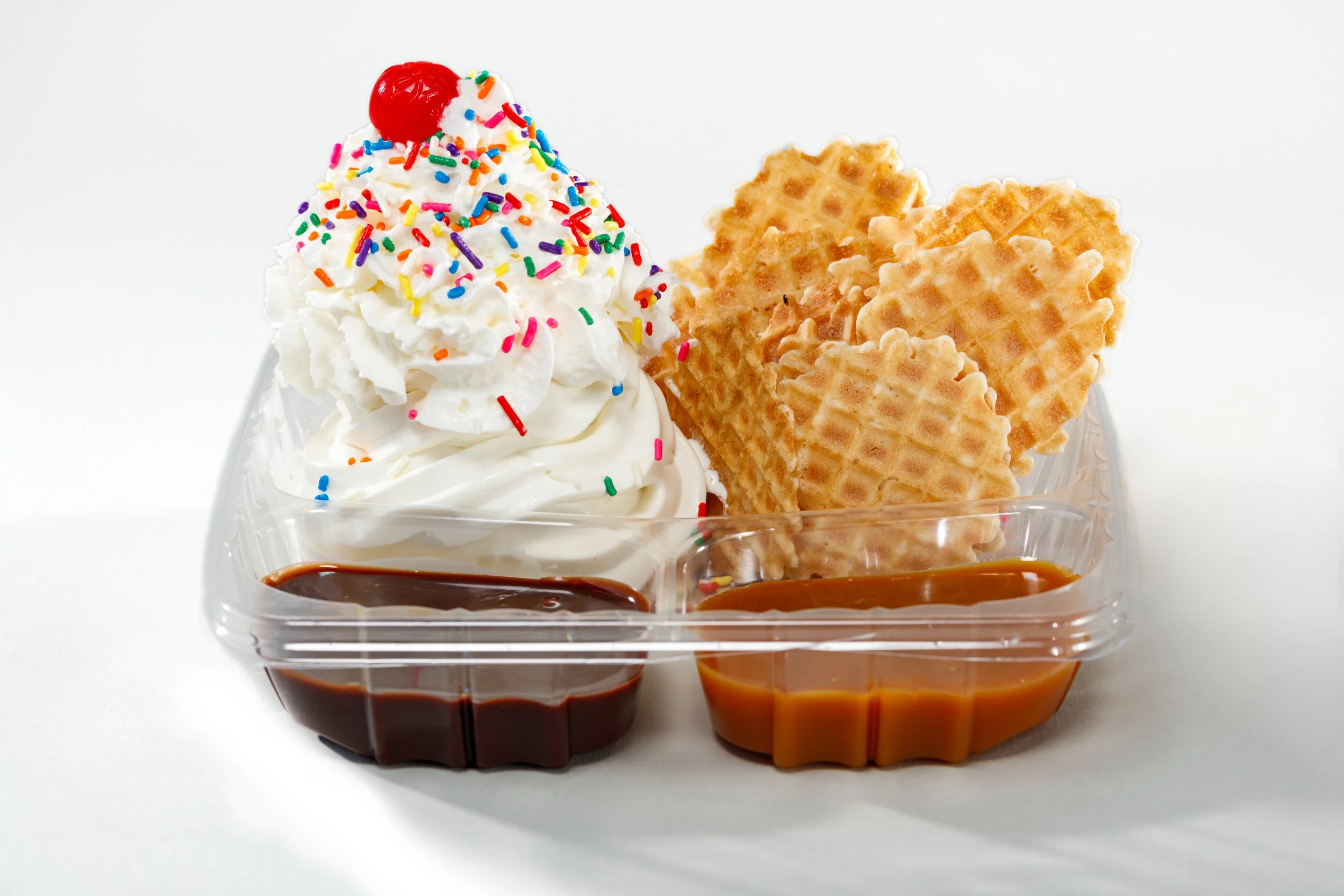 NACHOS! Our homemade waffle chips served with your choice of vanilla, twist or chocolate soft serve ice cream, your choice of two toppings, whipped cream, chocolate or rainbow sprinkles and a cherry!