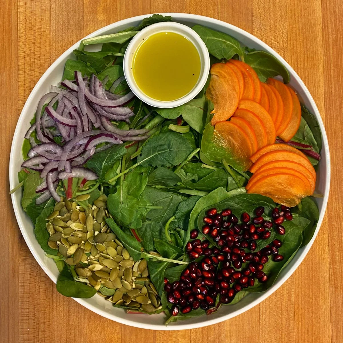 power greens, fuyu persimmon, pomegranate, pepitas, red onion, lemon vin.jpg