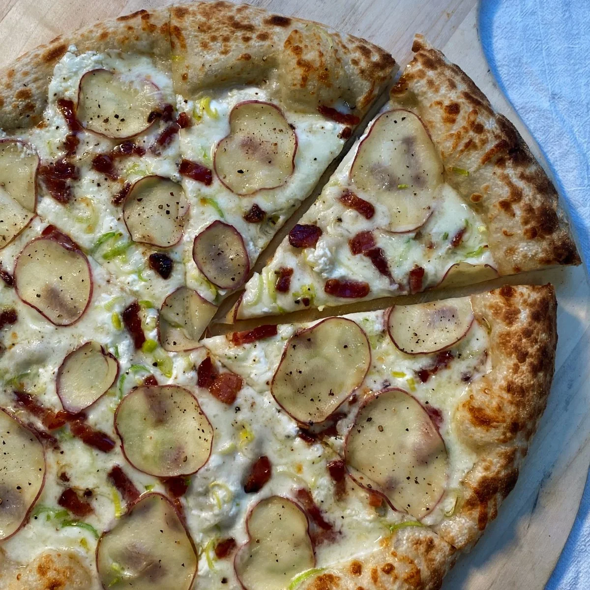 Bacon, roasted potatoes, leeks, sour cream, cheddar-gruyere, black pepper.jpg