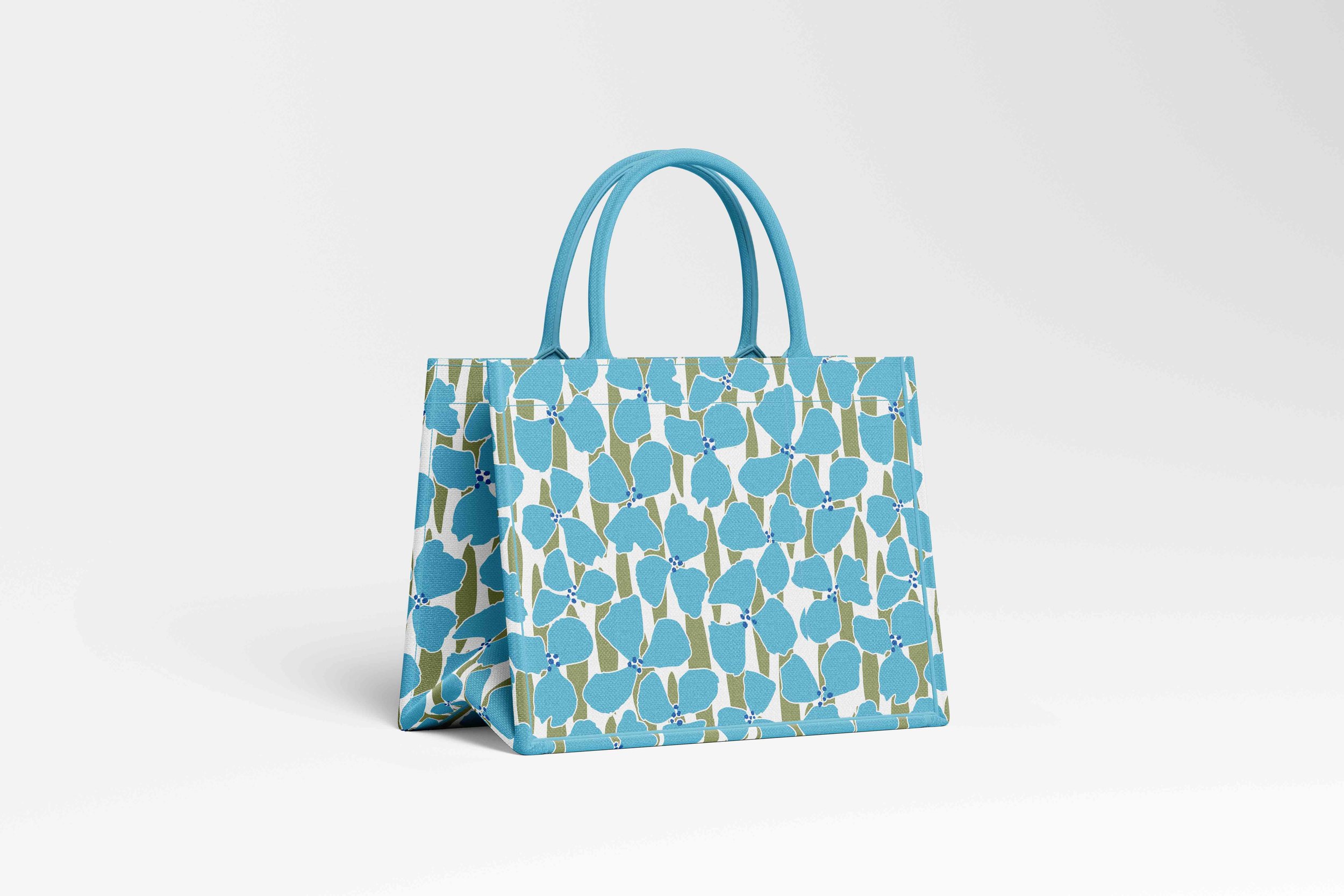 Colorful patterned tote bag with a Nelly and Isobel blue and green design featured on it.