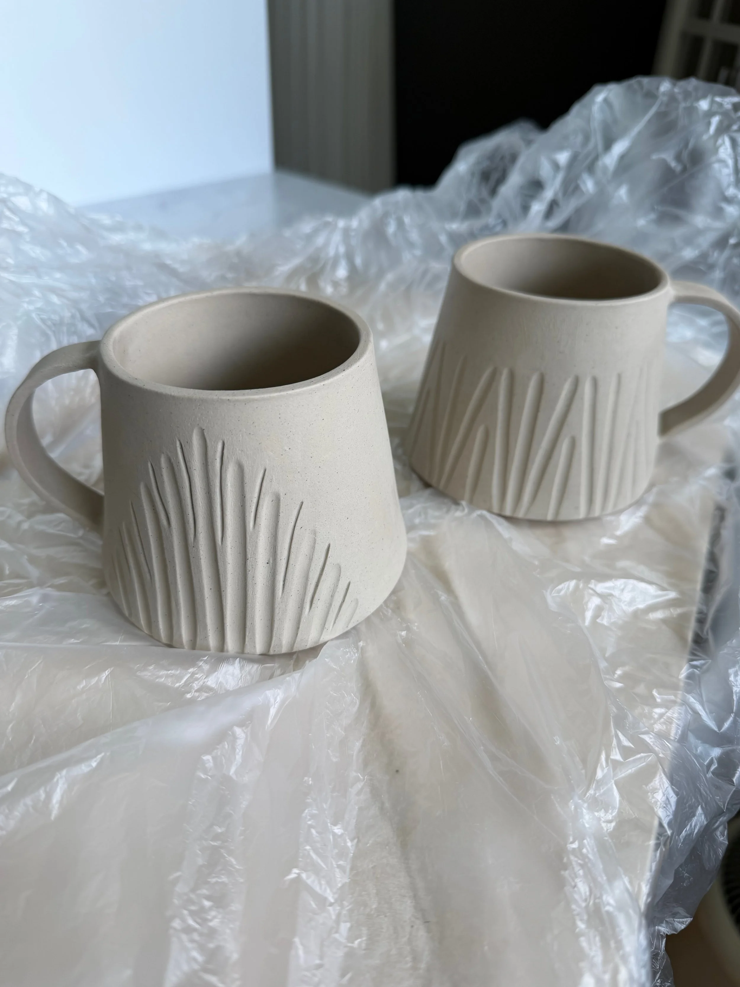 Carved handbuilt mugs