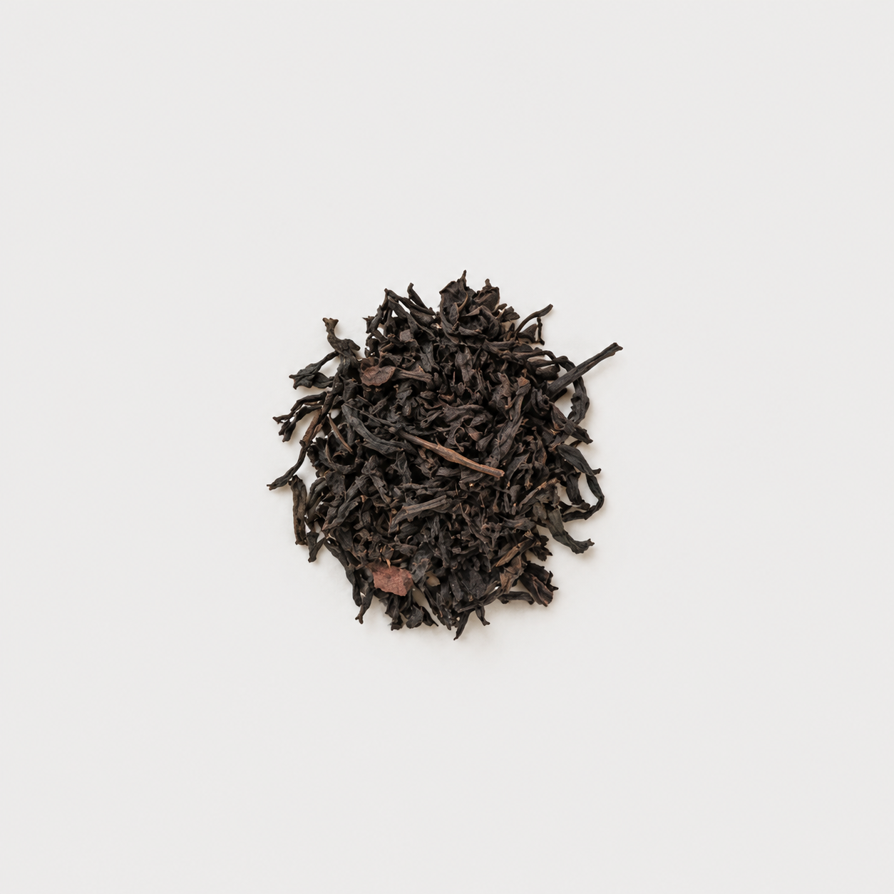 Loose Black Tea Leaves on Pale Background.png
