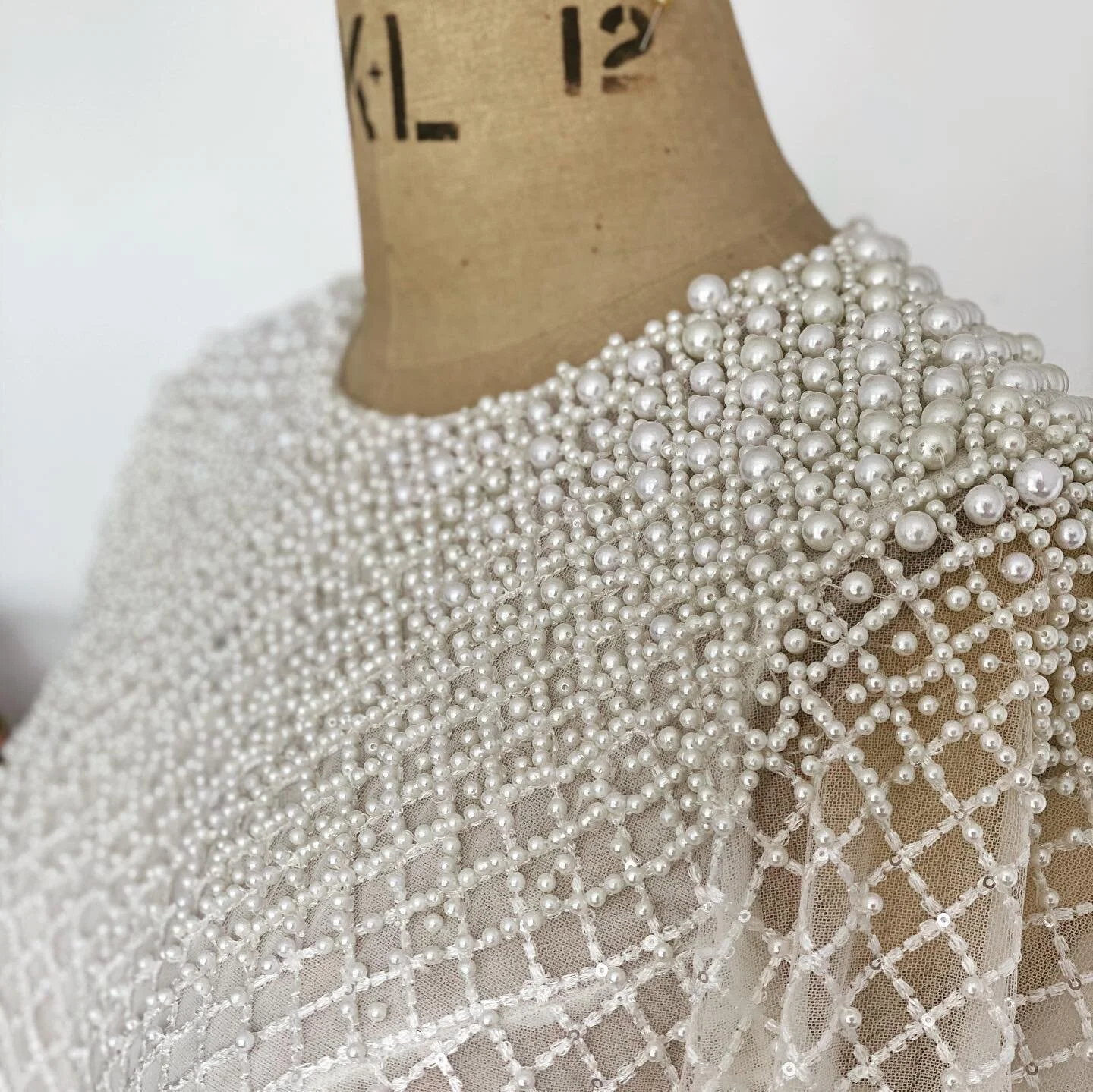 Hundreds of tiny pearls in all shapes and sizes come together to create this intricate gown shining in our studio today π€ #emmabeaumont