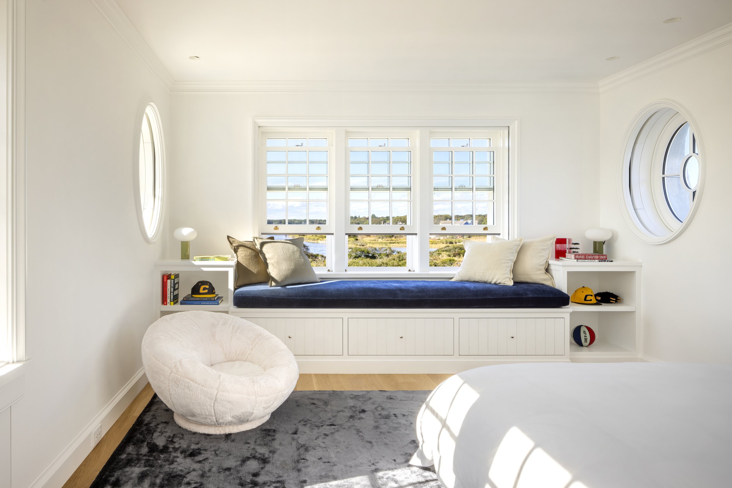 A bedroom suite over the entry addition has three exposures, and special pivoting oval windows.