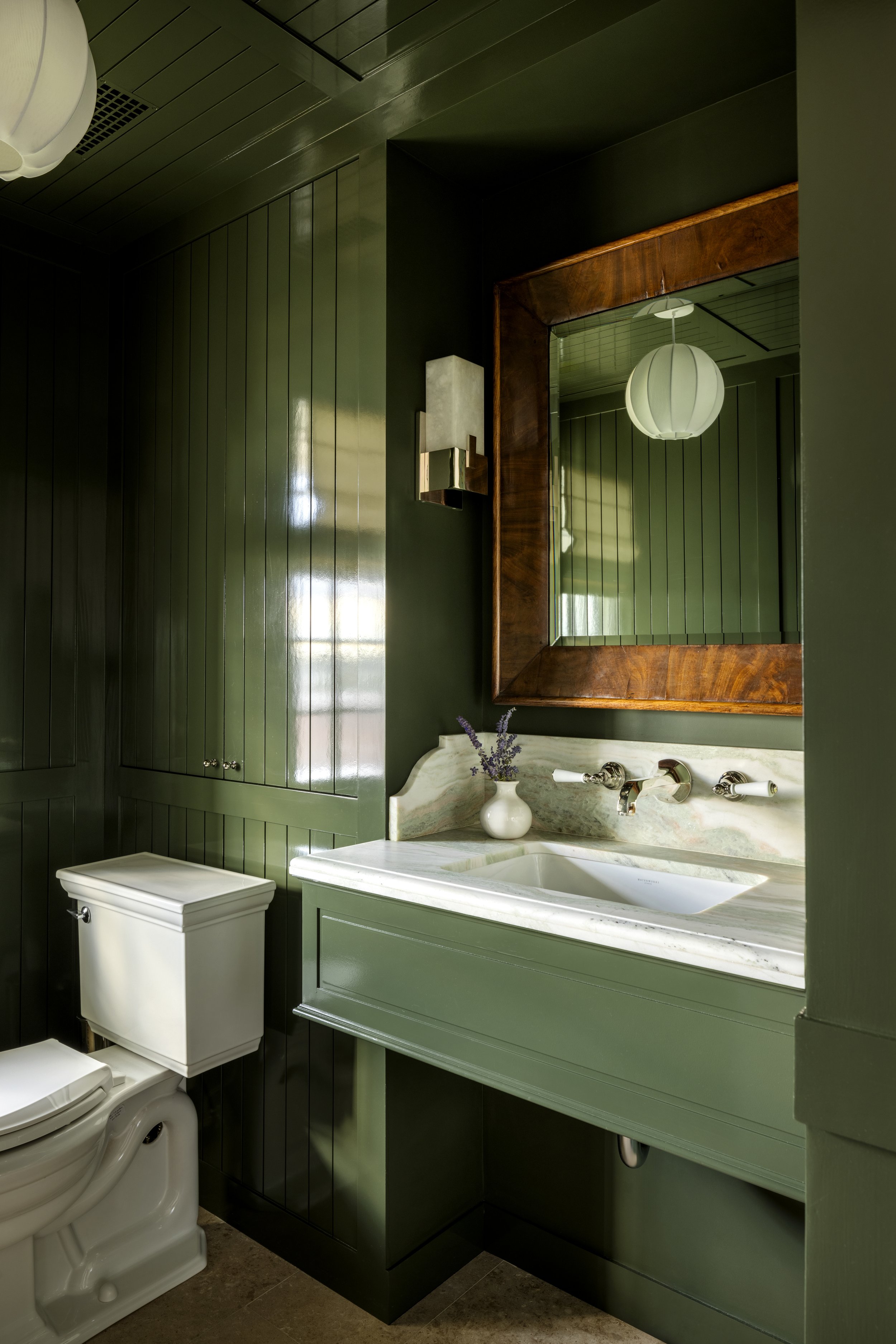 The warm green powder room is a perfect quiet respite.