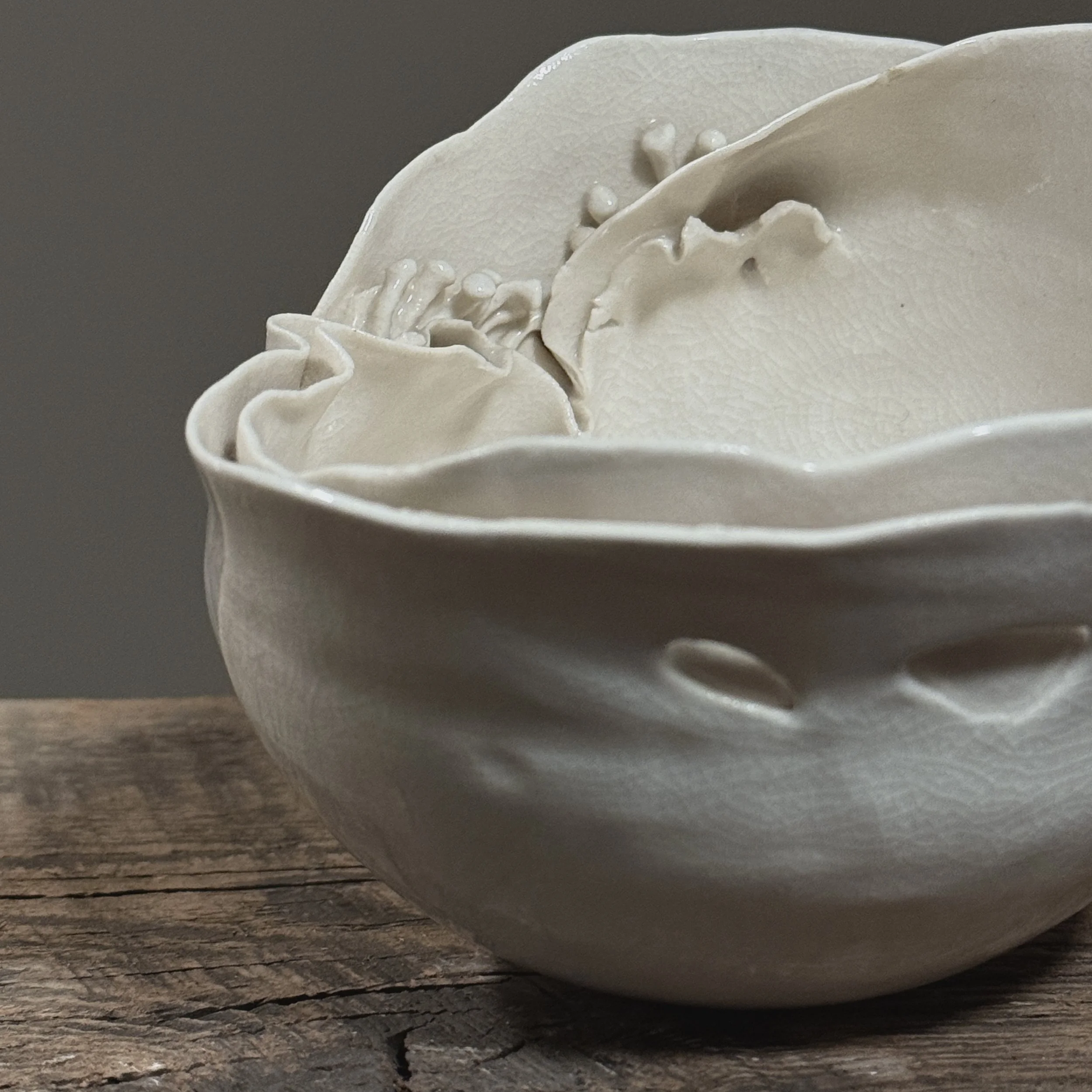 Crackle glaze studio pottery vessel with organic spore details