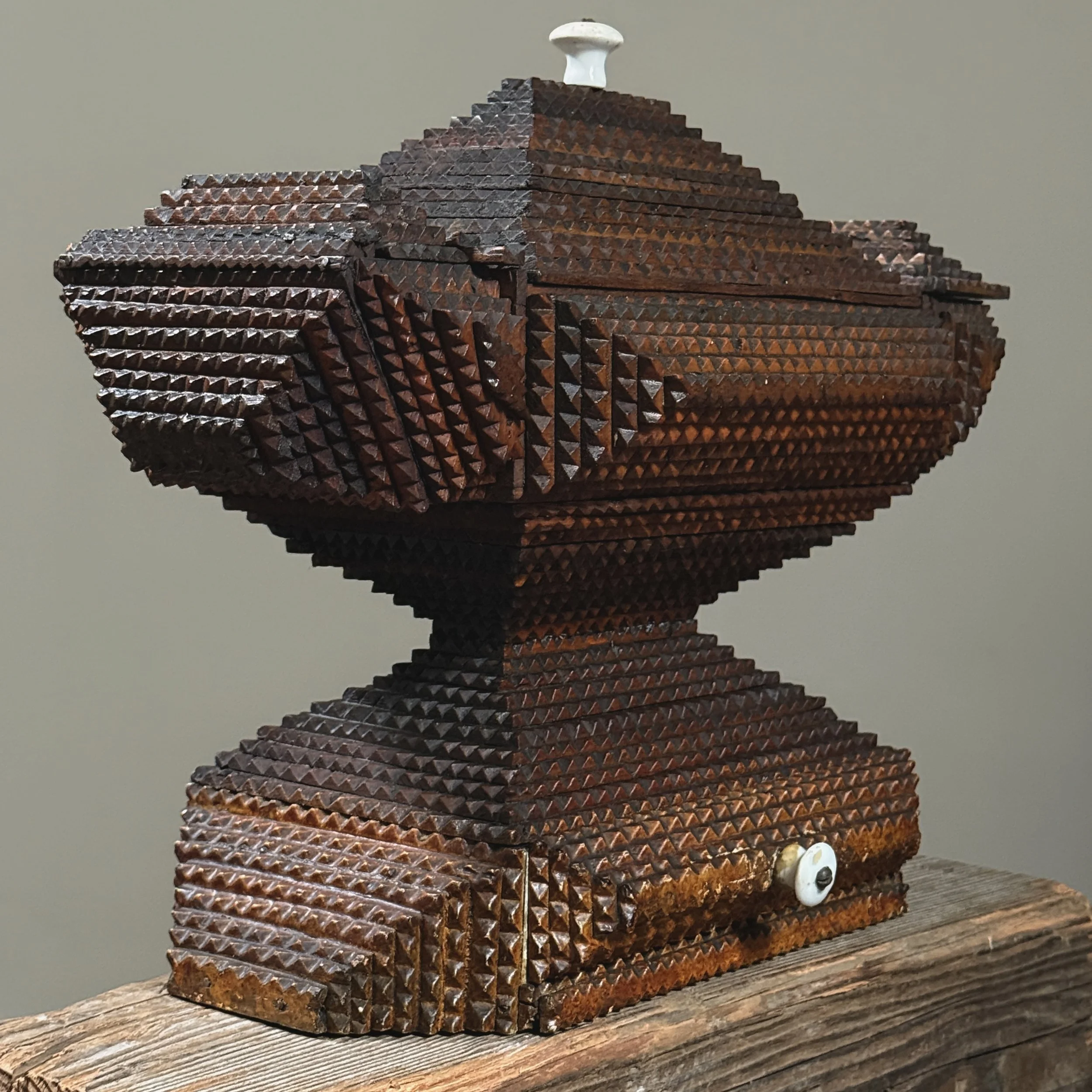 Double pyramid tramp art box with layered chip-carved folk art design, side view