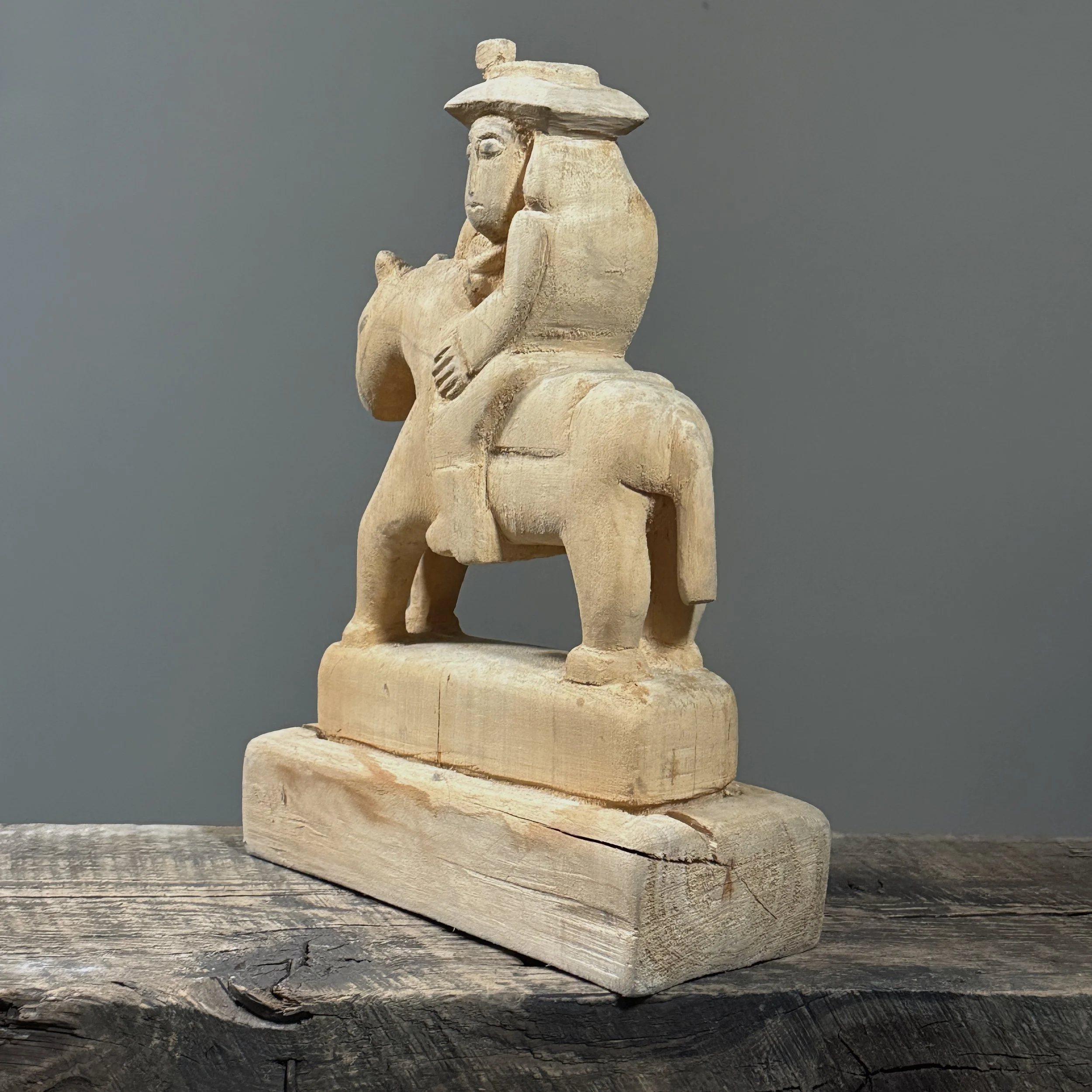 Side profile of the folk art wood carving showing its depth and form