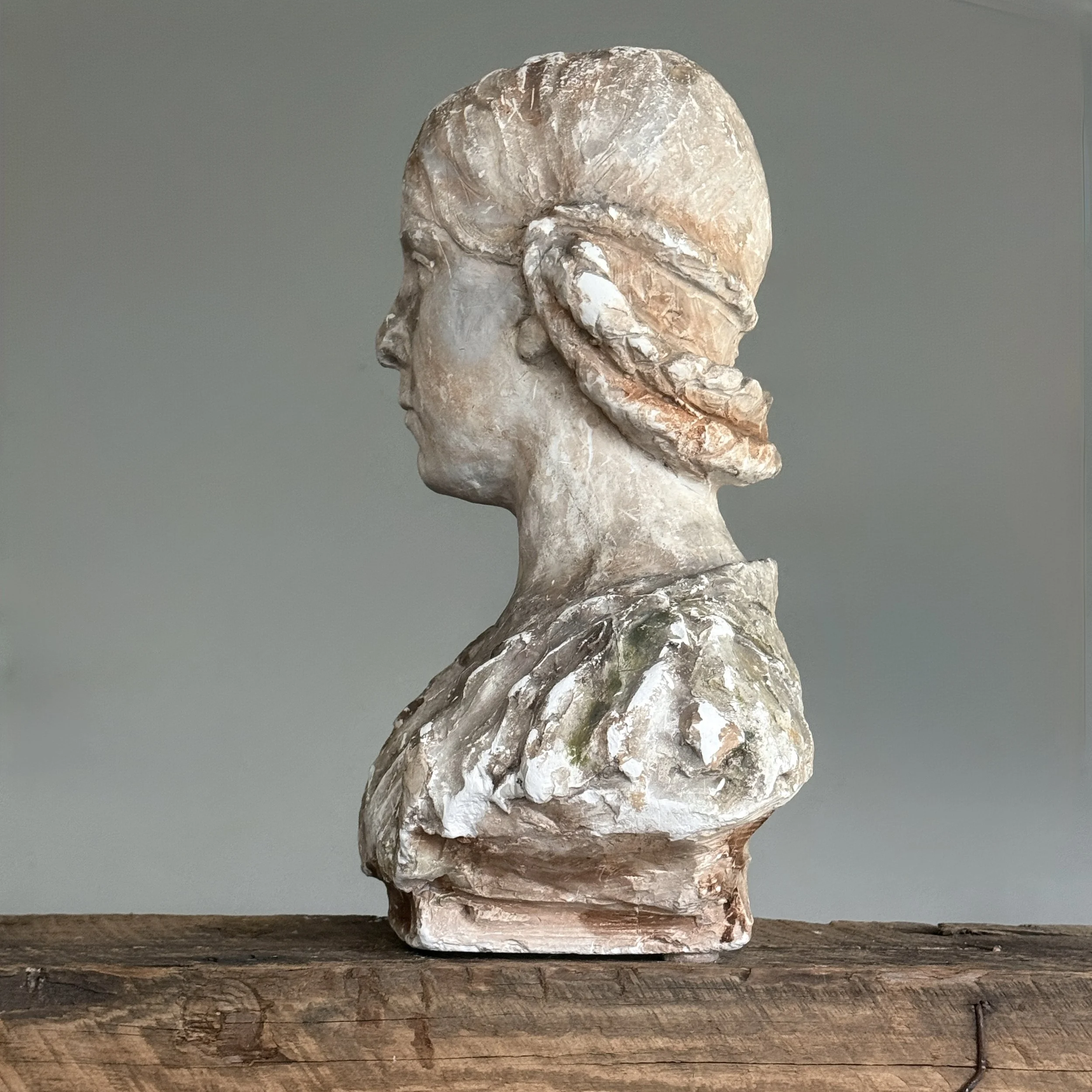 Side profile of Renaissance-inspired bust showing braided hairstyle