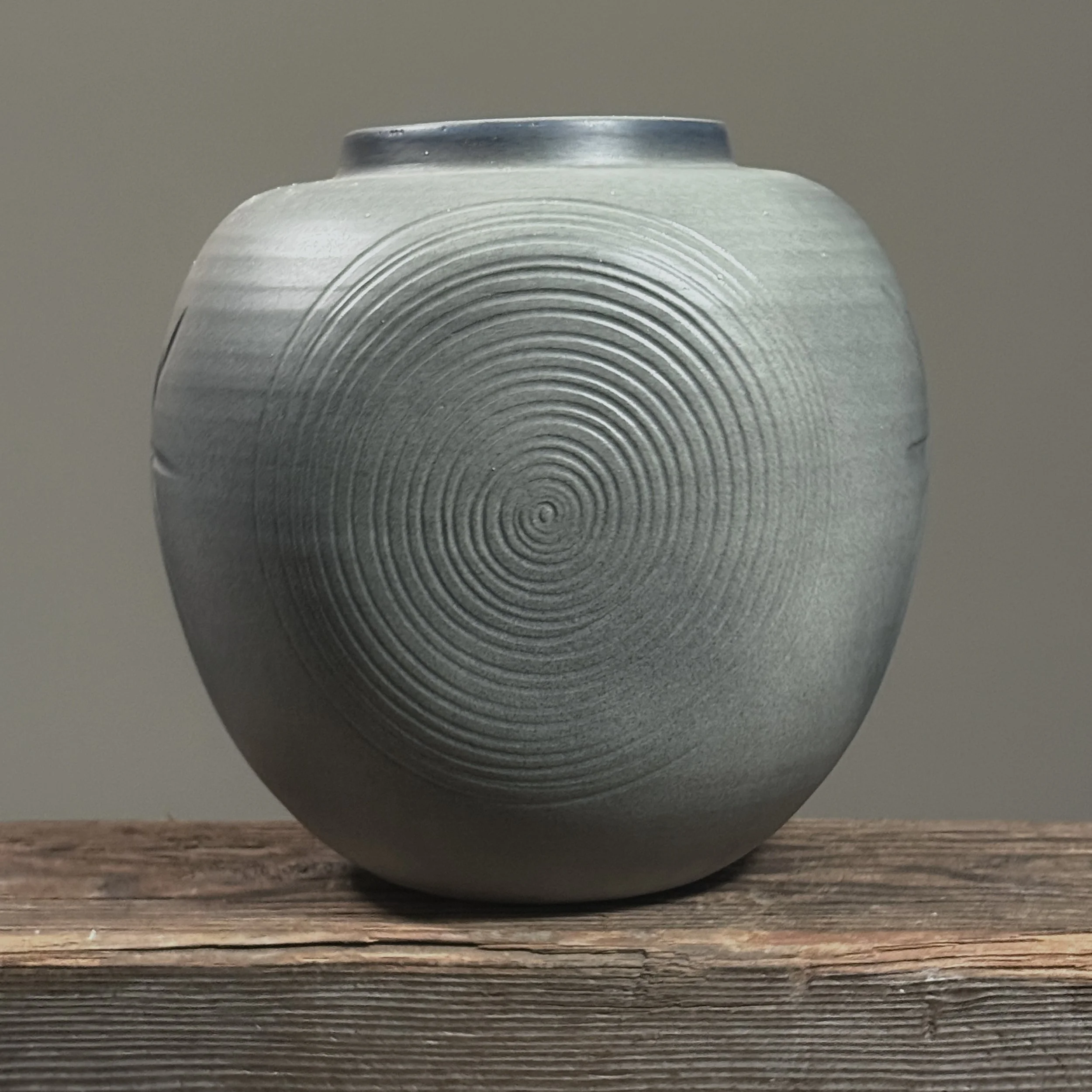 Side view showing swirl motif on Japanese minimalist vase