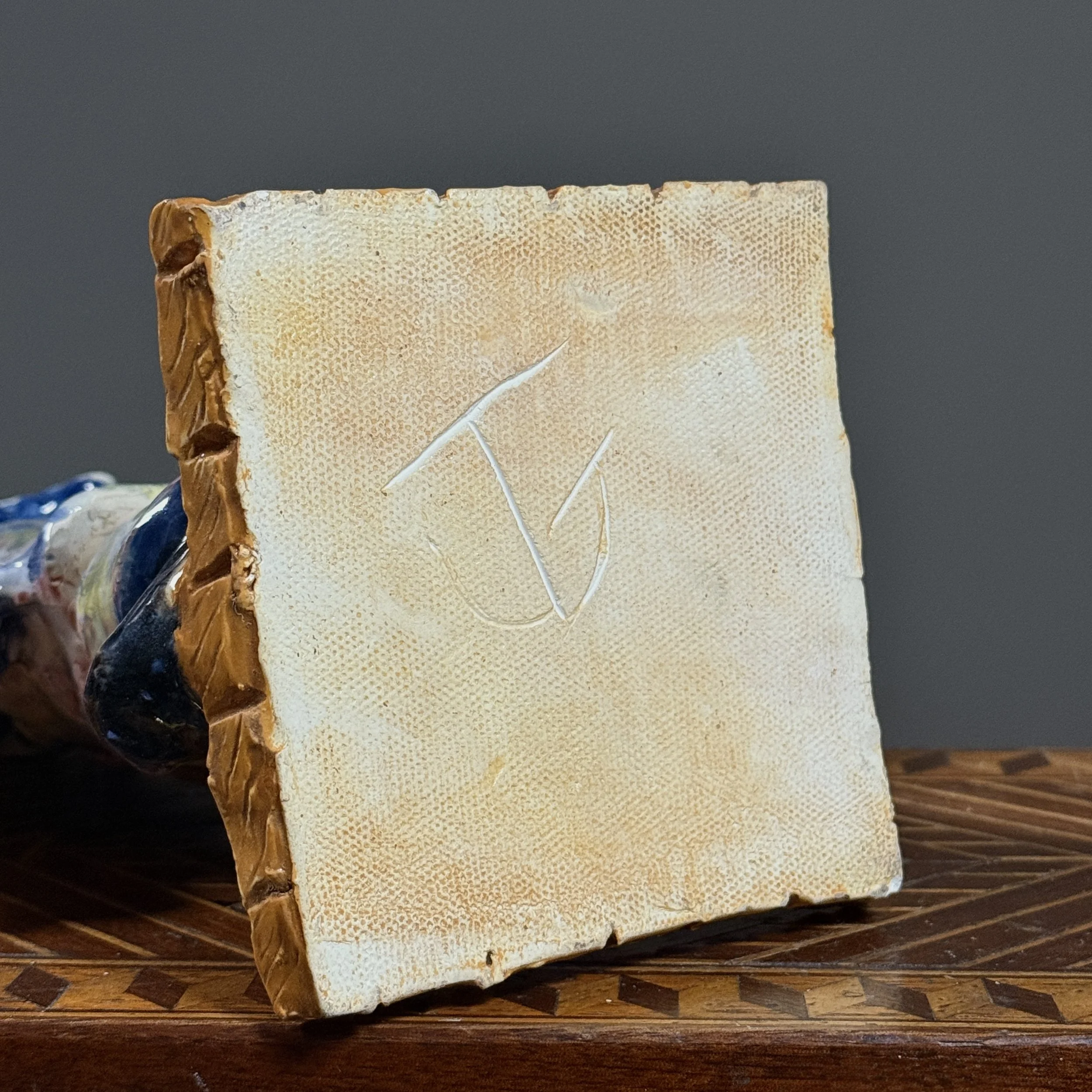 Underside of the base showing the signature.