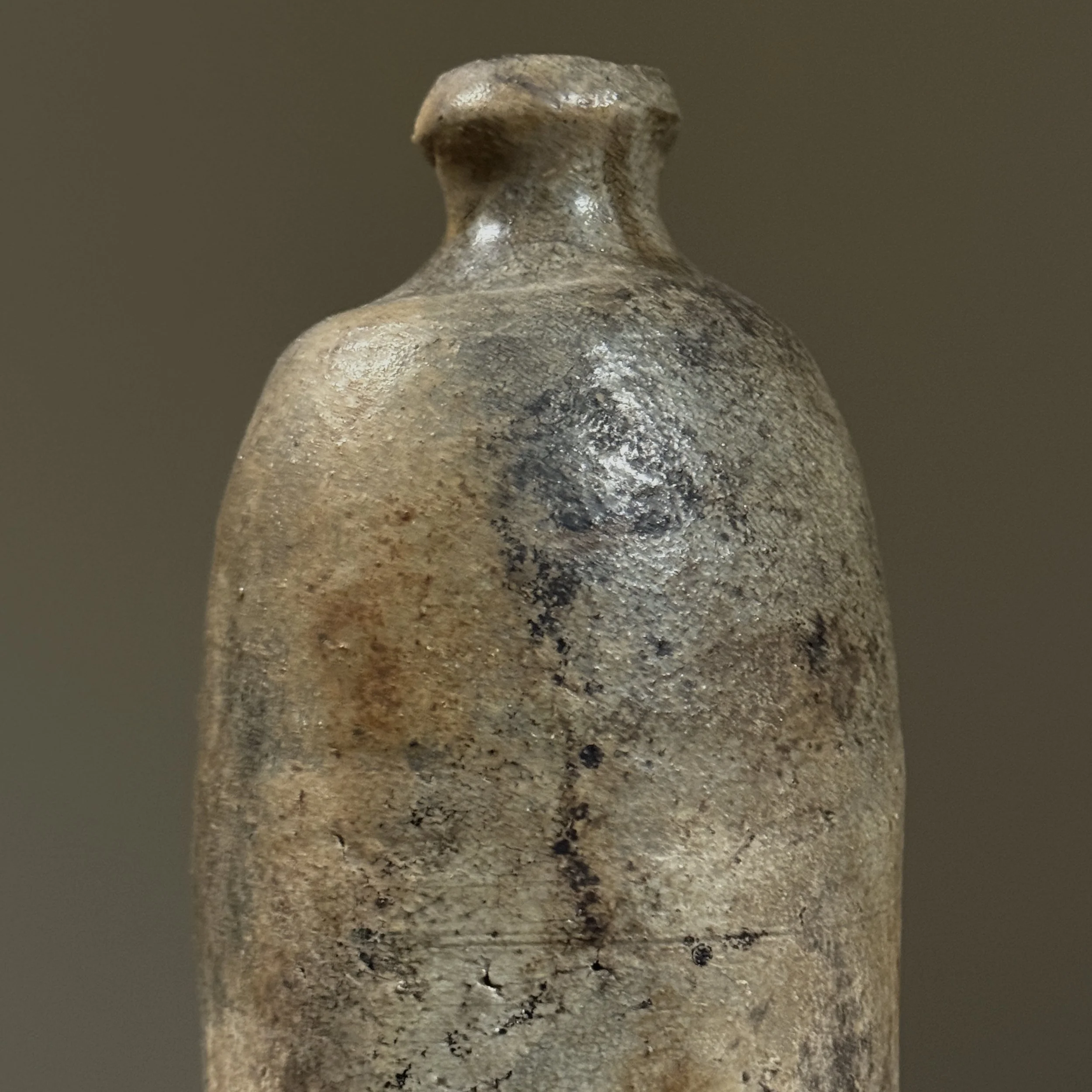 Profile view showing the bottle's globular form and narrow neck.