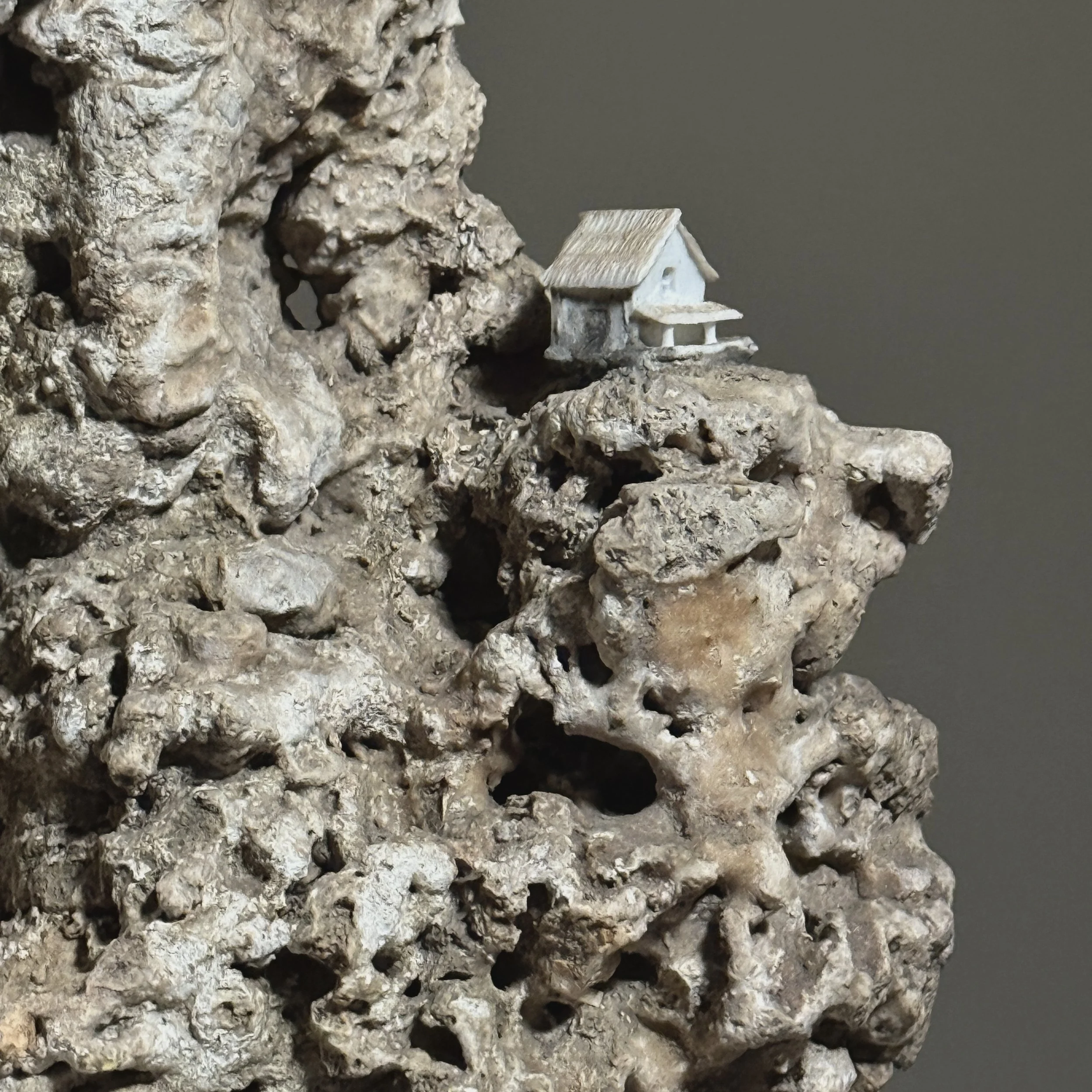 Close-up of porcelain houses on Suiseki stone surface