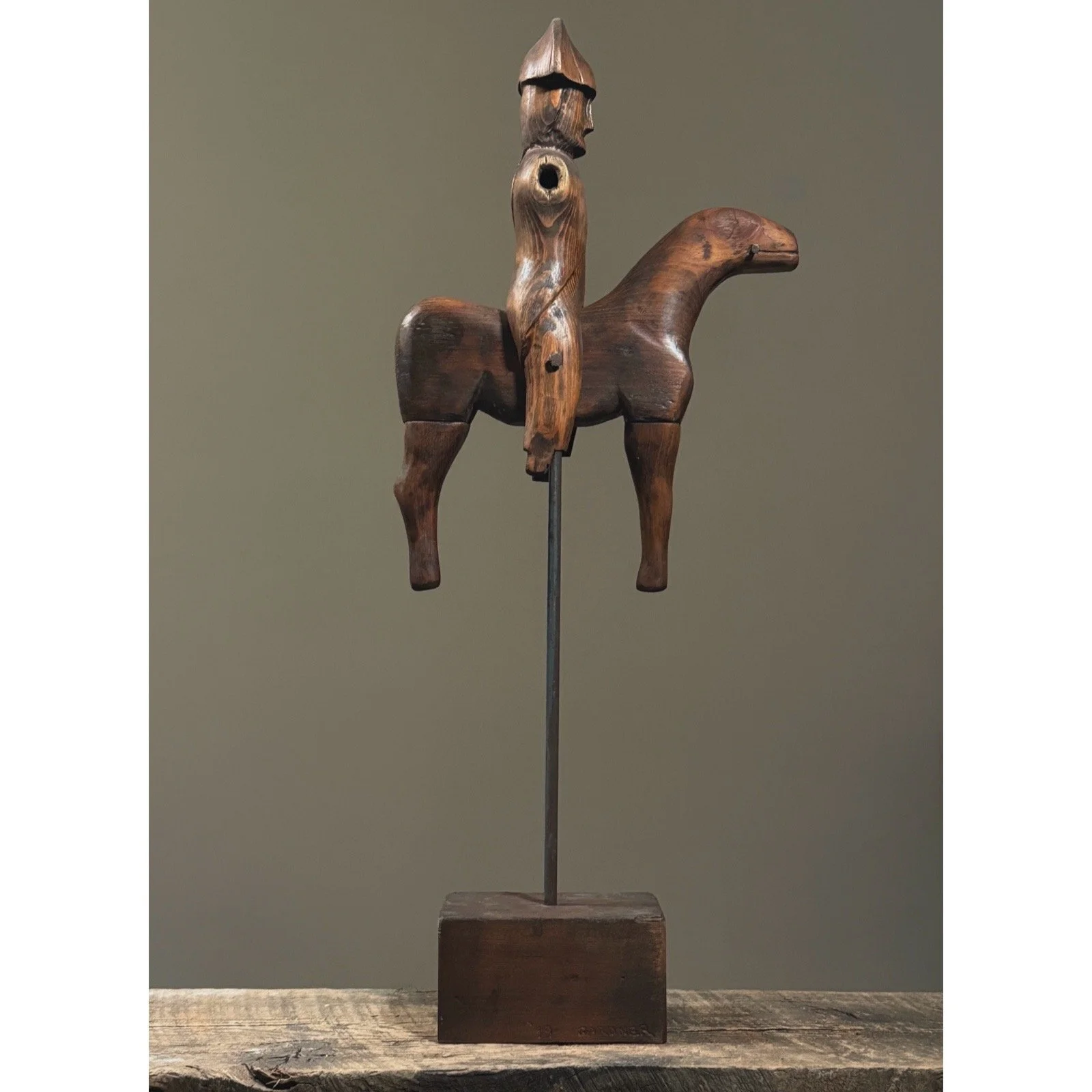 Three-quarter angle of sculpture on display stand.