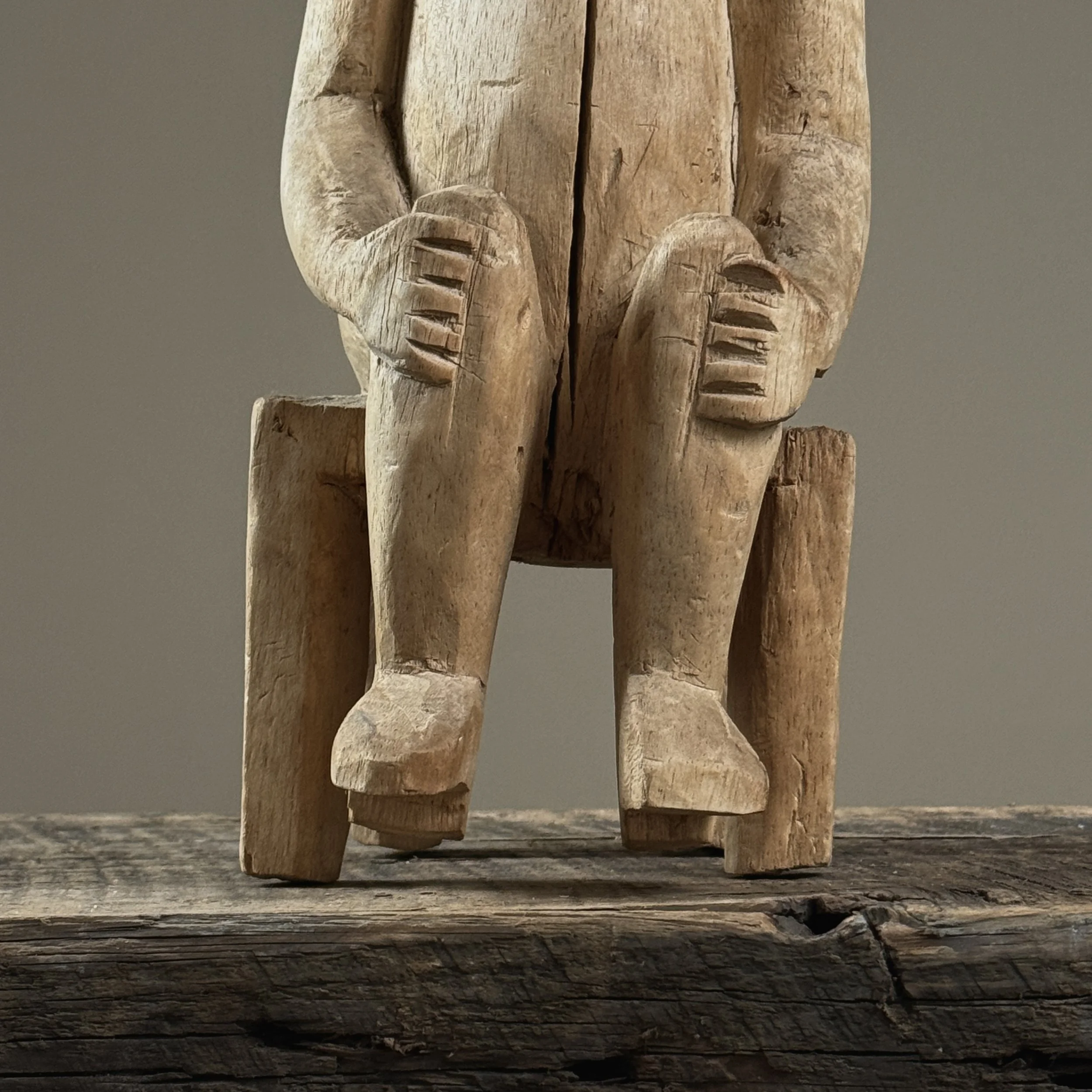 Seated posture detail, Guna nuchu, carved wood figure