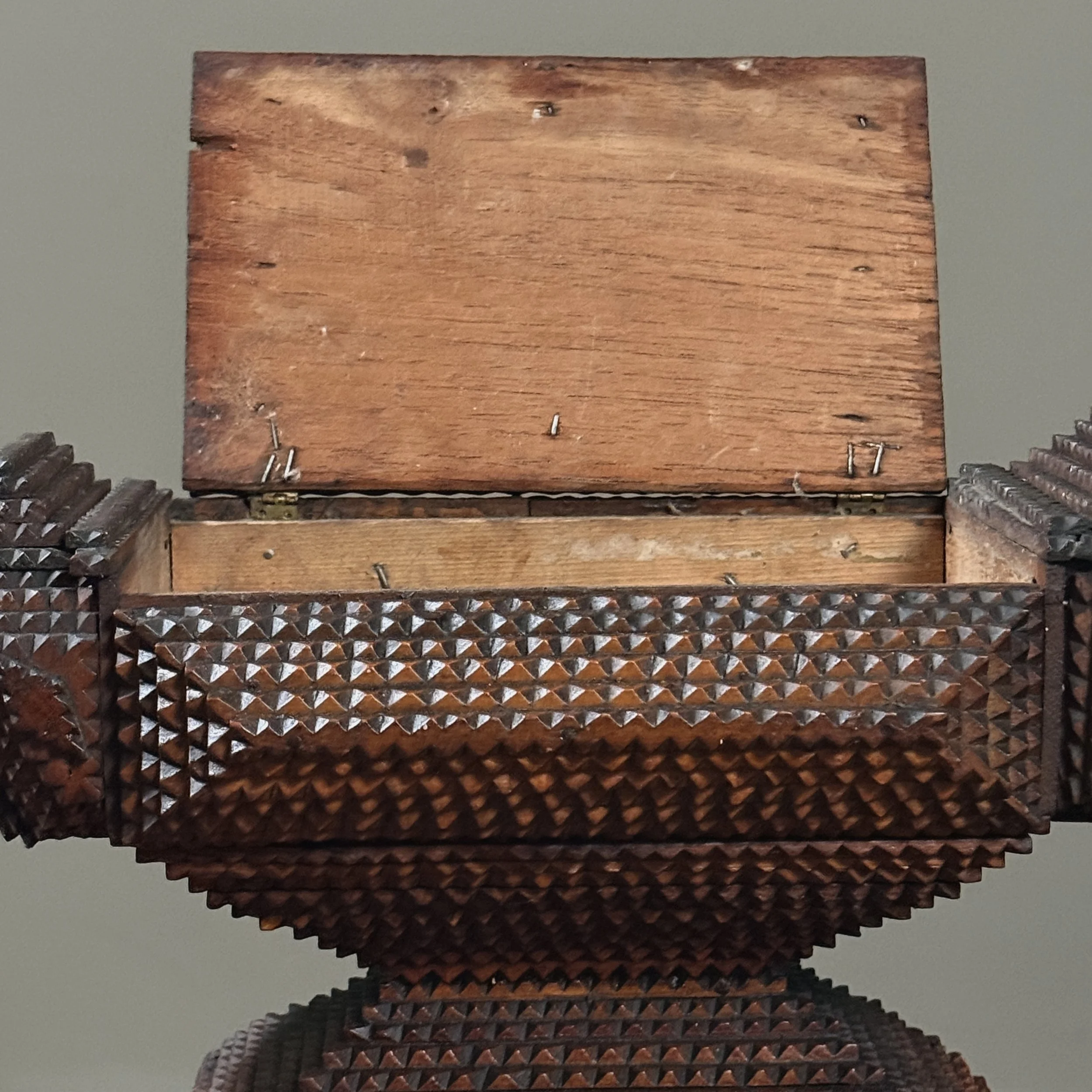 Interior view of hinged main compartment on antique tramp art box