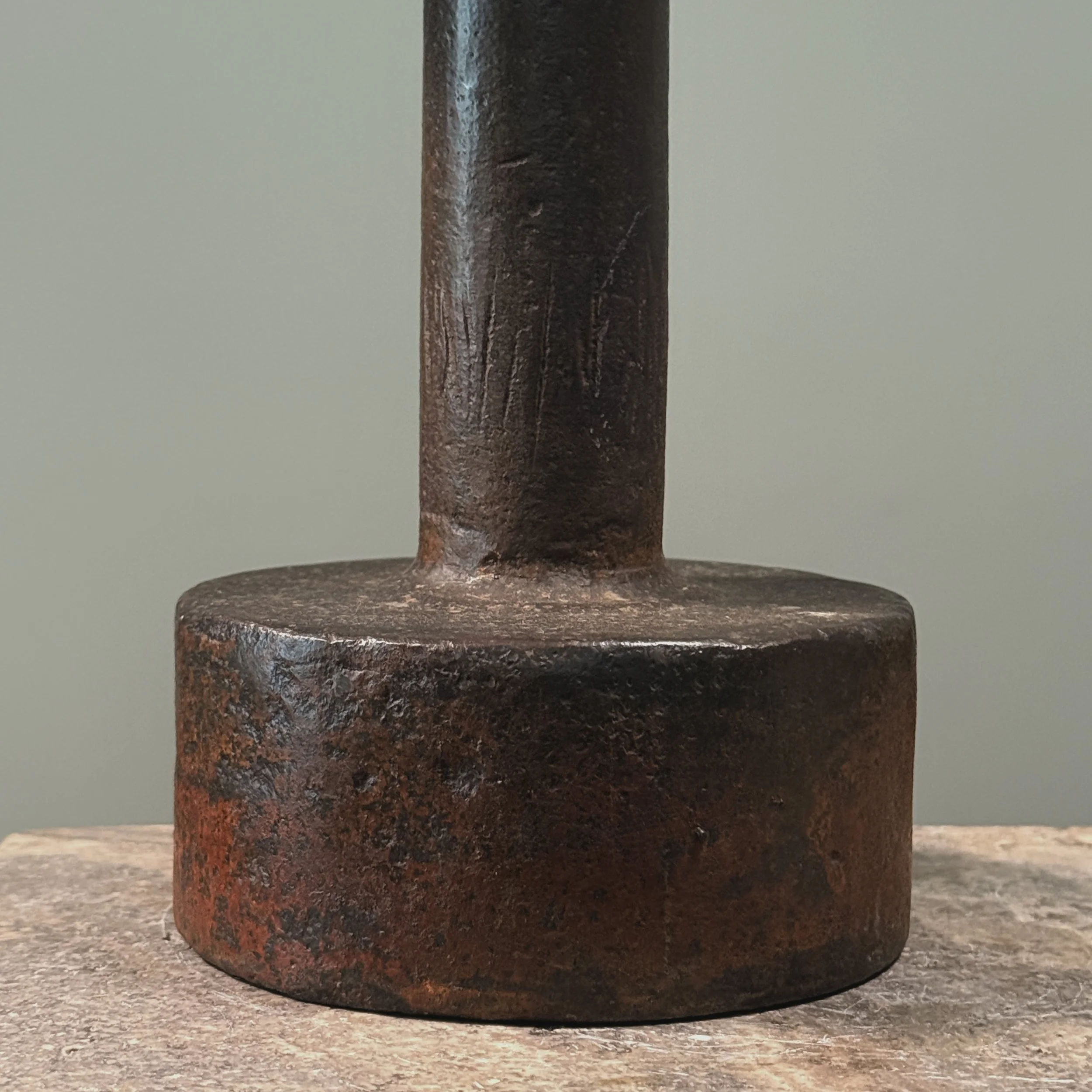 Close-up of forged iron elements. Raw material texture and industrial finish visible.