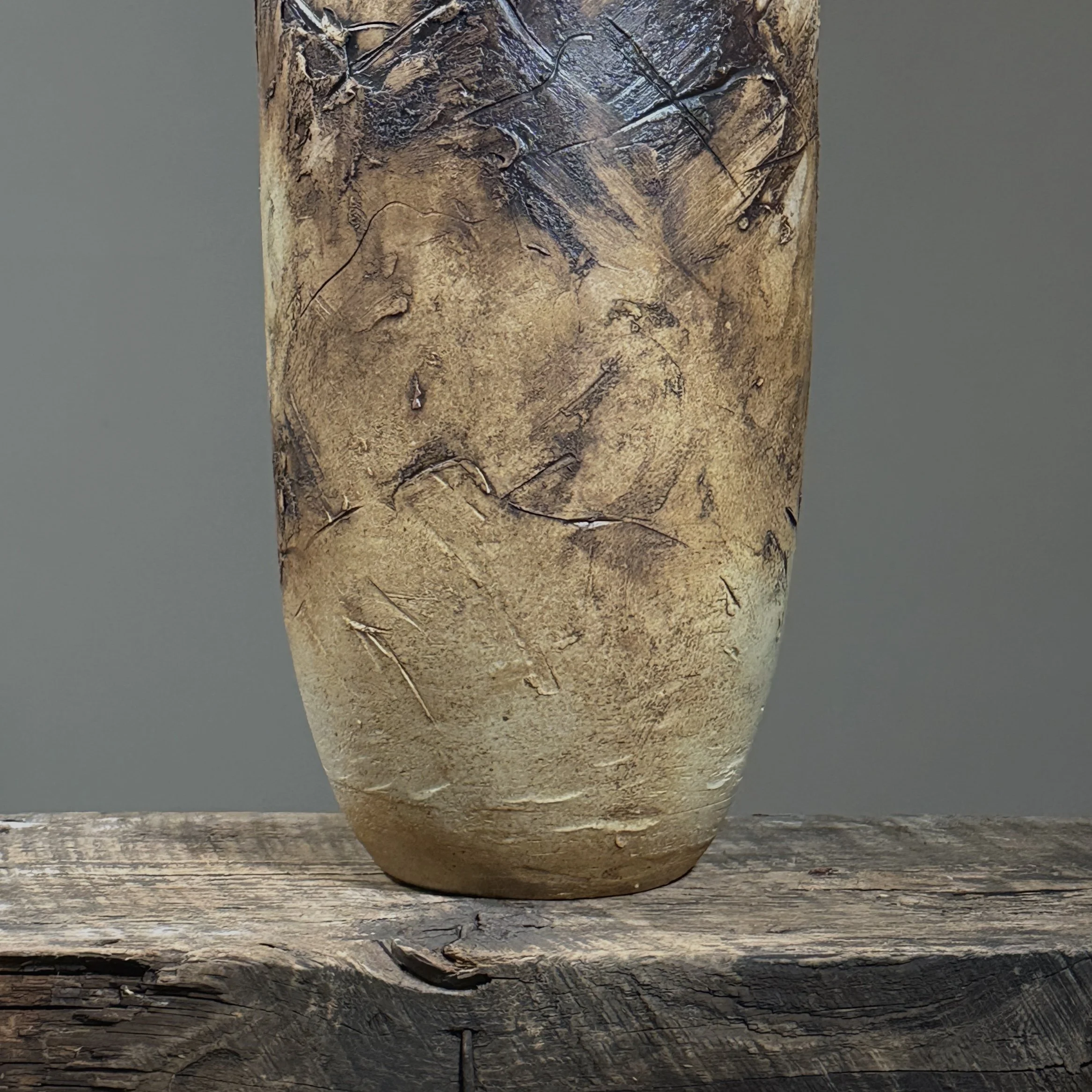 Textured carved clay details on vintage vase