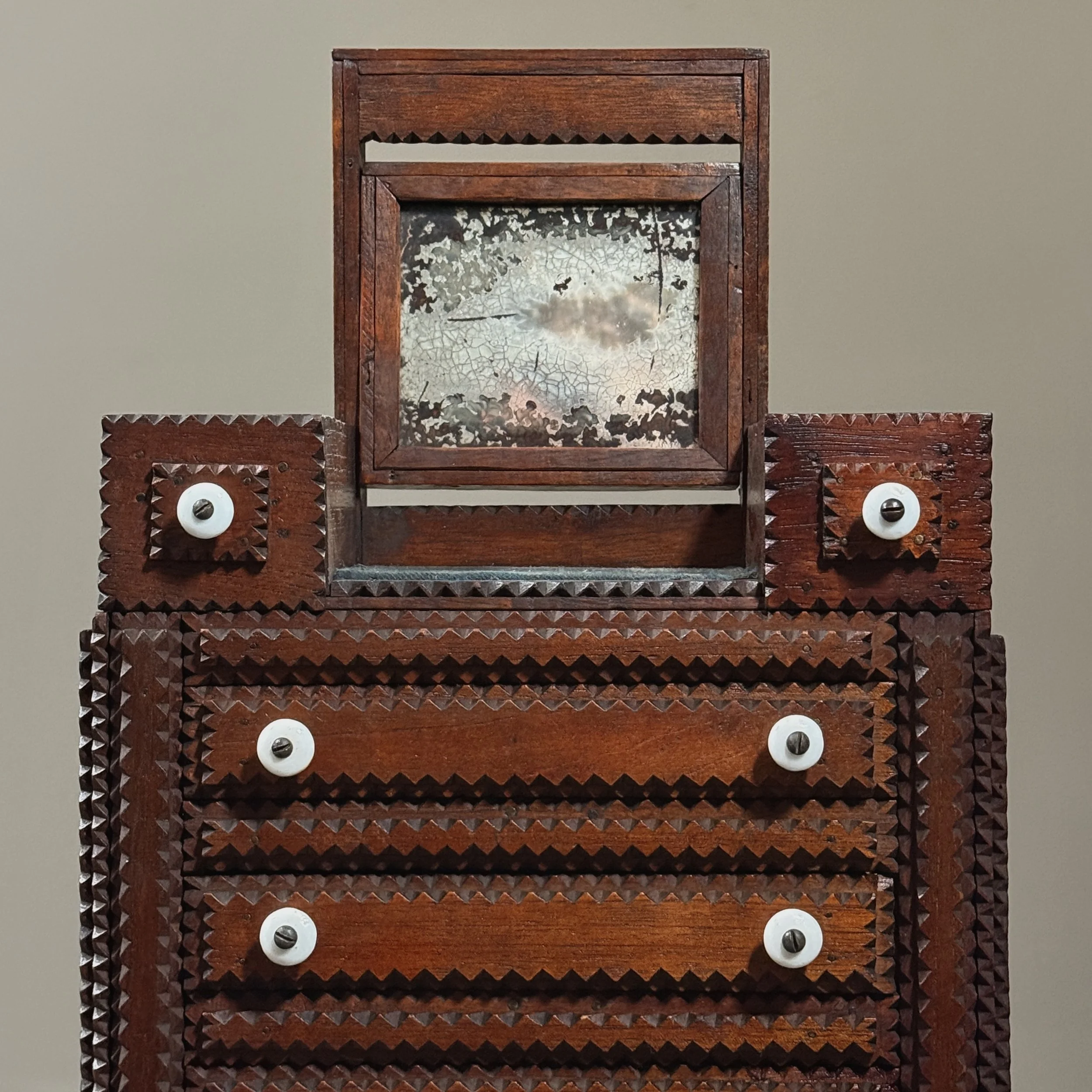 Close-up of the patinated, hinged mirror in its upright position