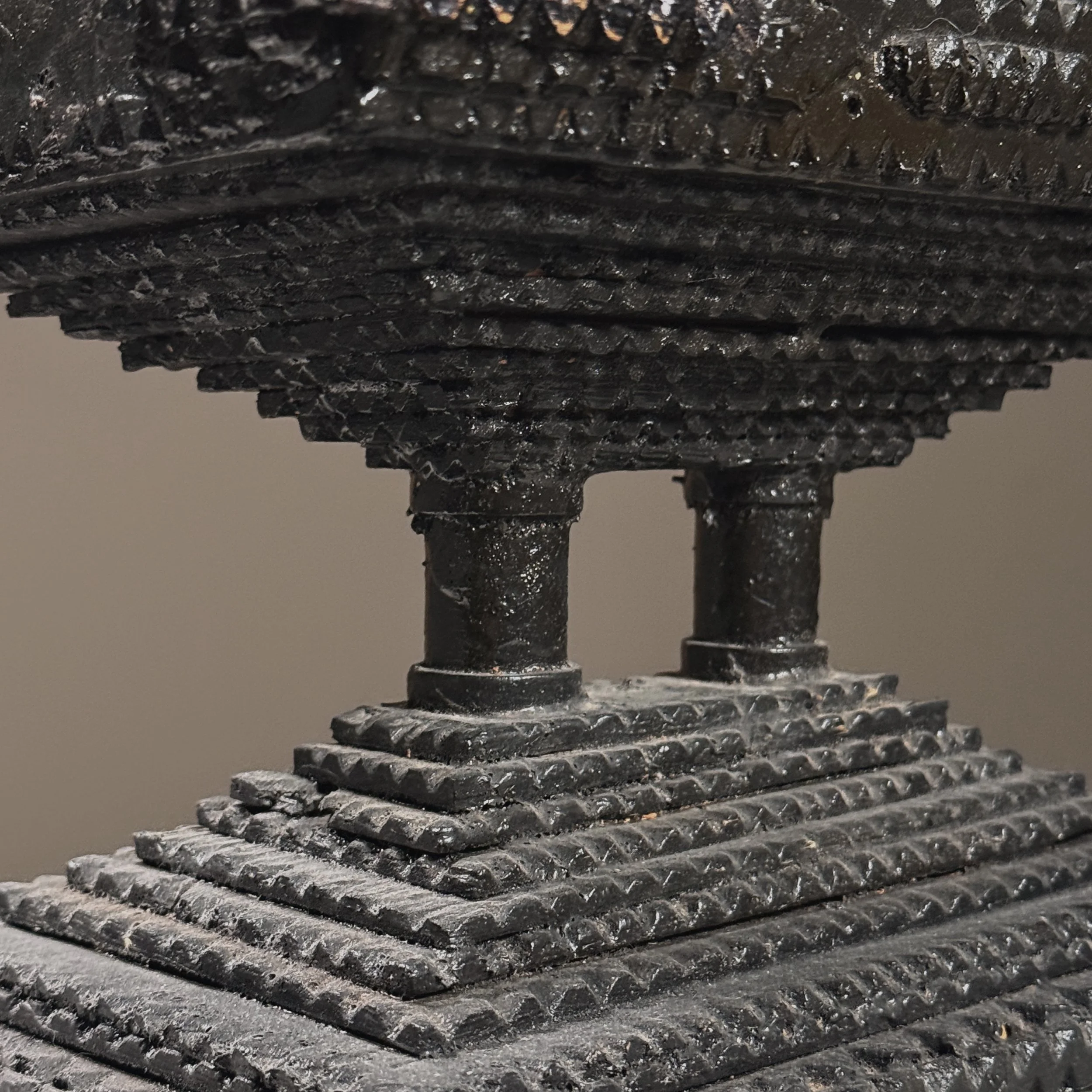 Macro detail of chip-carving technique and black painted finish with age-appropriate wear