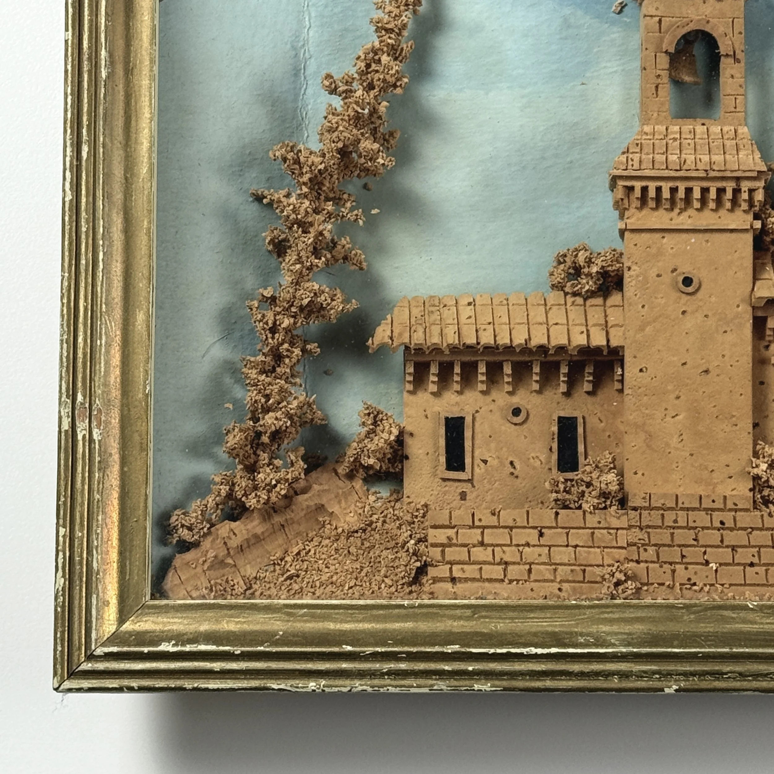 Hand-painted clouded backdrop behind cork church model