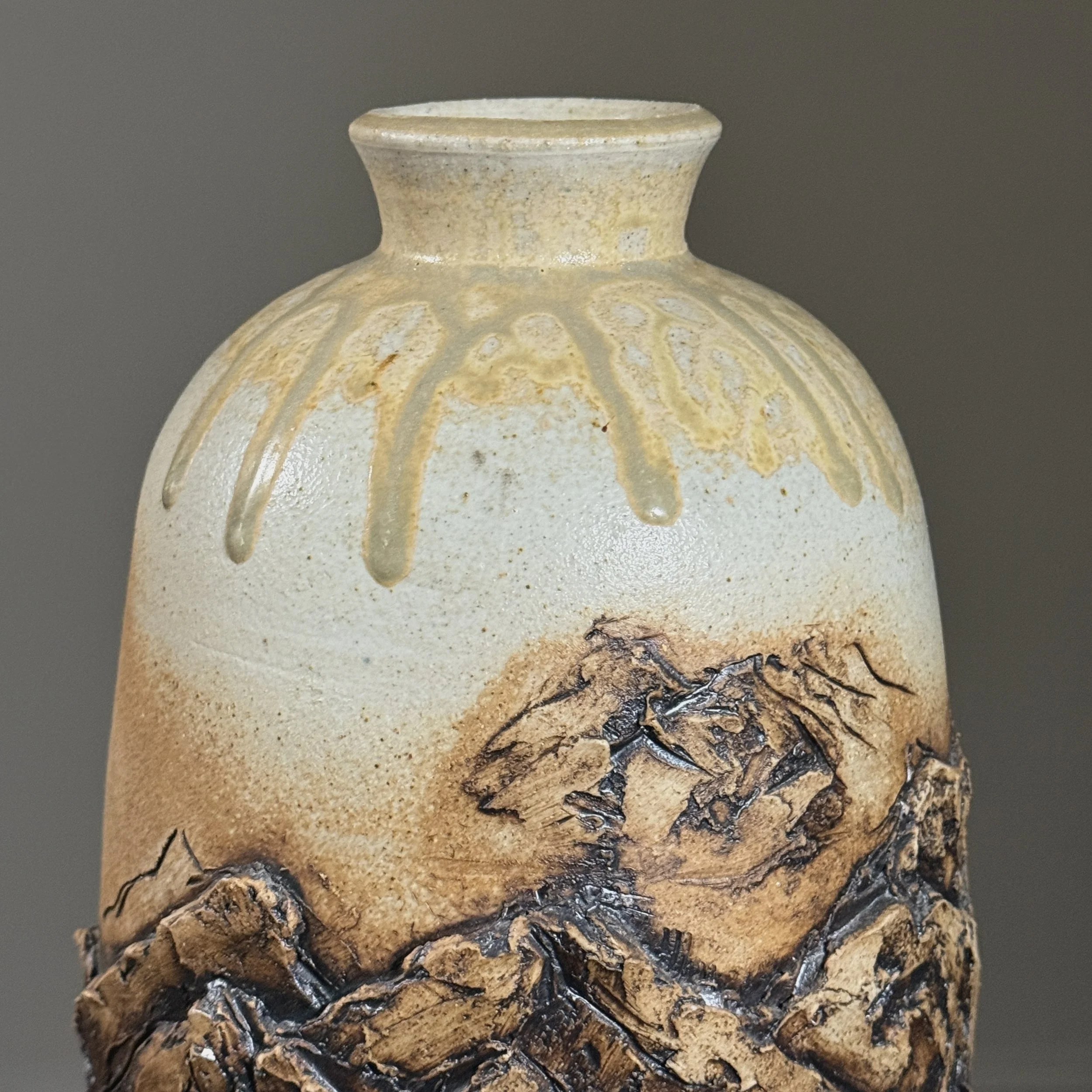 Textured carved clay details on vintage vase