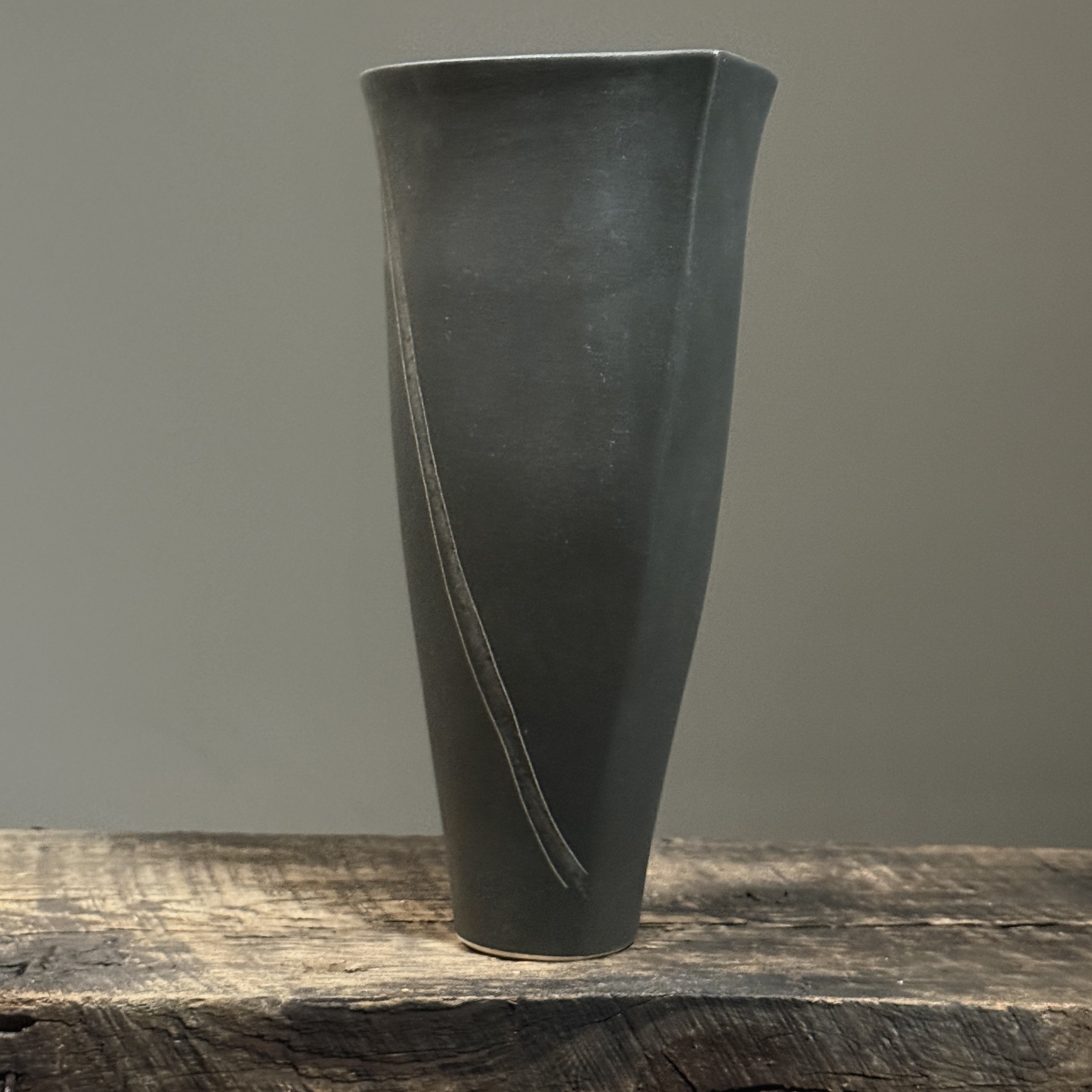 Side view of Vintage Postmodernist Japanese black matte porcelain ikebana vase. V-shaped. 10.5 inches height.