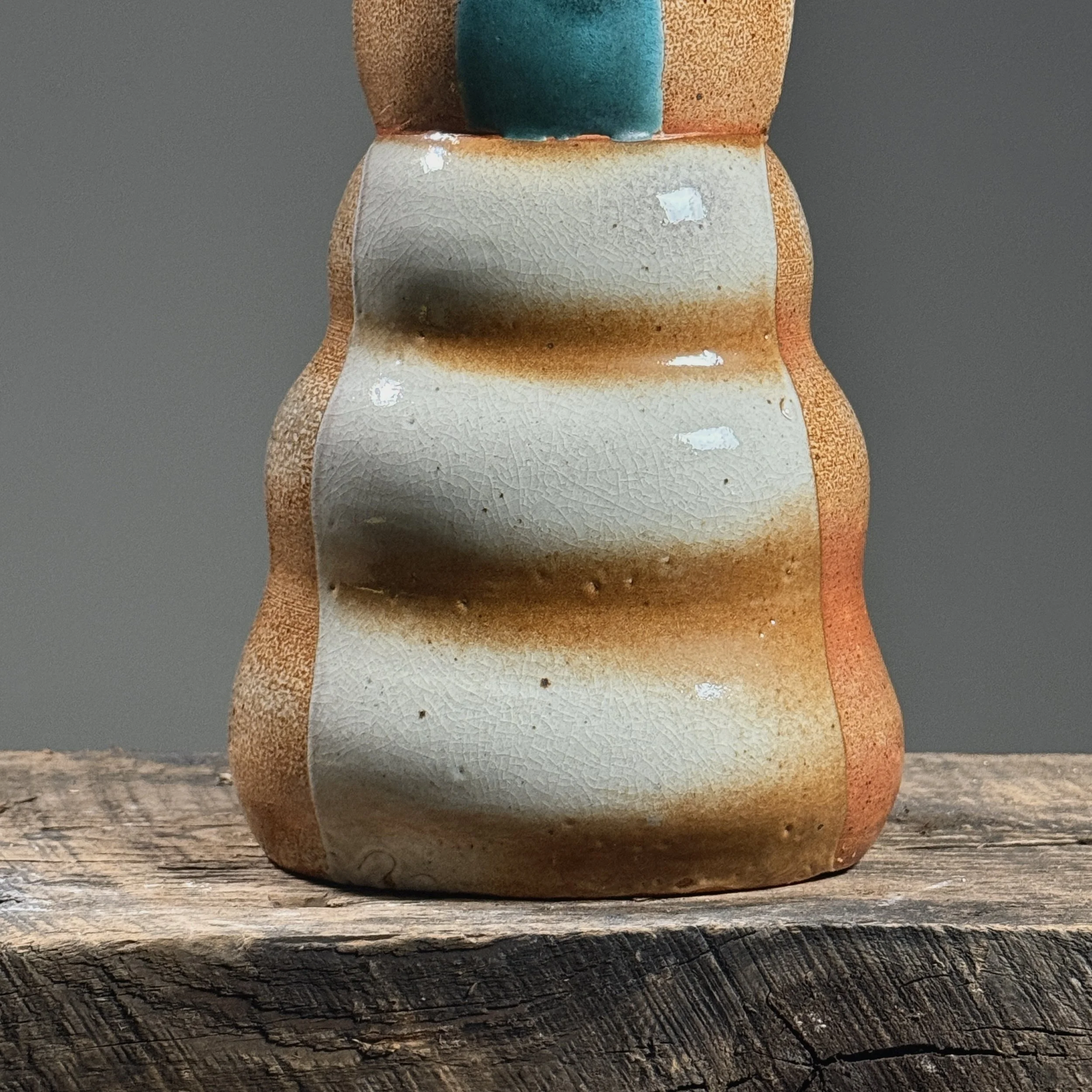 Close-up of the orange-peel texture characteristic of soda firing.