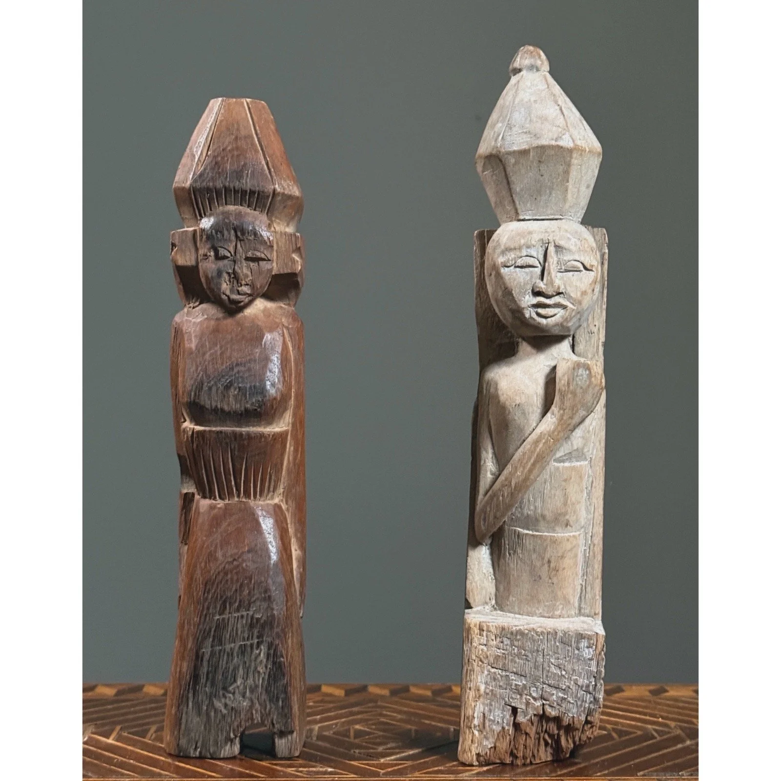 Museum-style display of antique folk art wooden figures