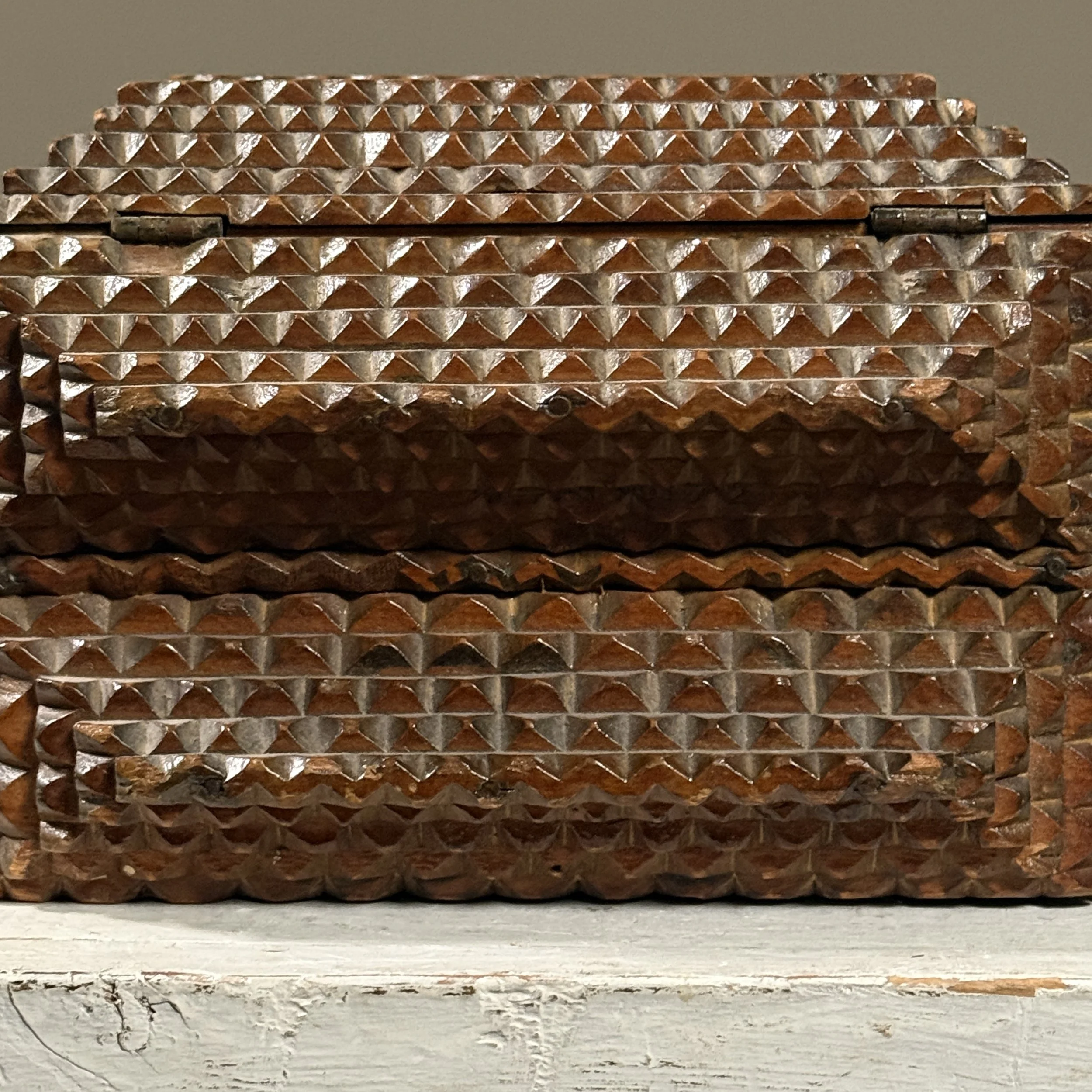Close-up of pyramid chip carving on tramp art box
