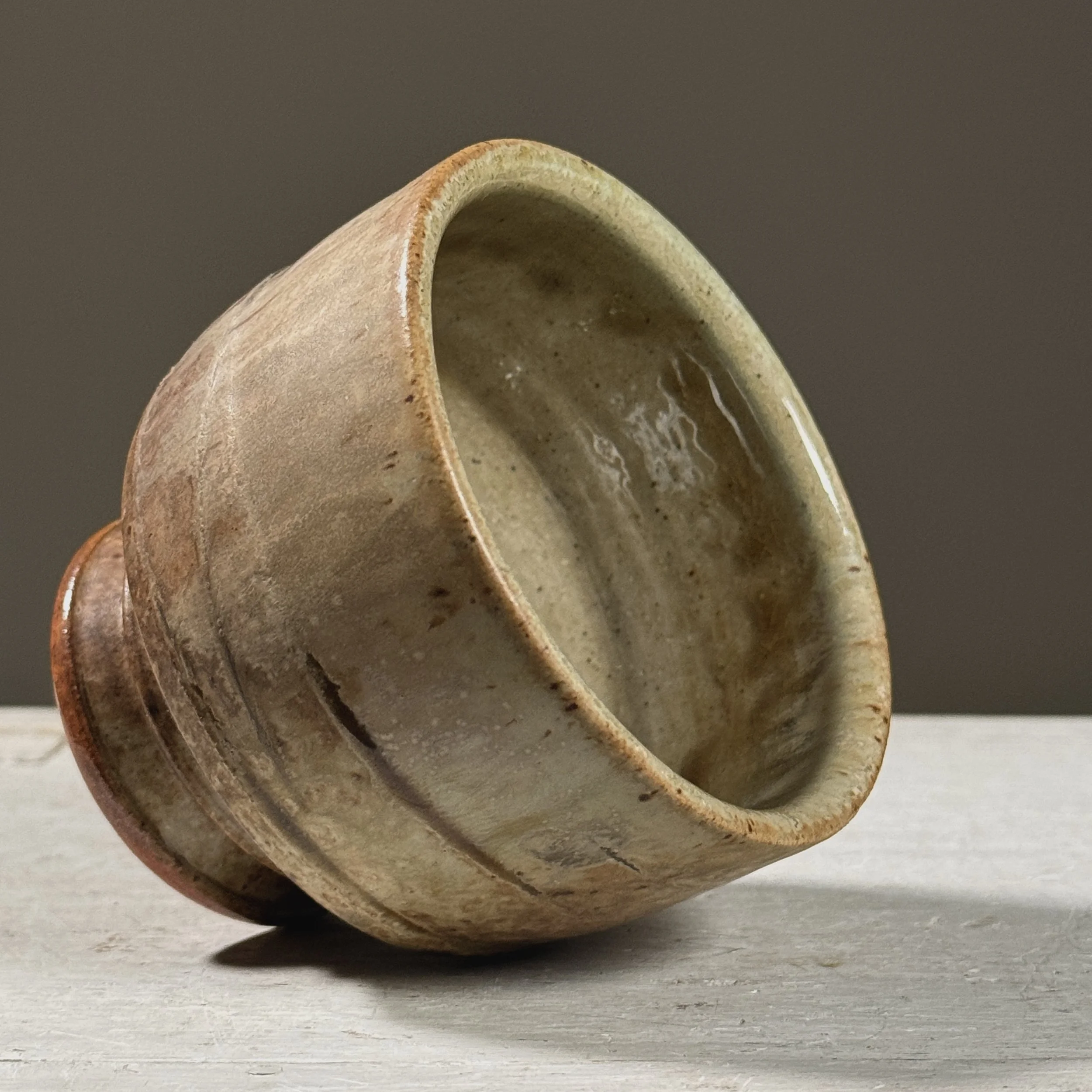 Angle emphasizing the interplay of ash and turquoise glazes.