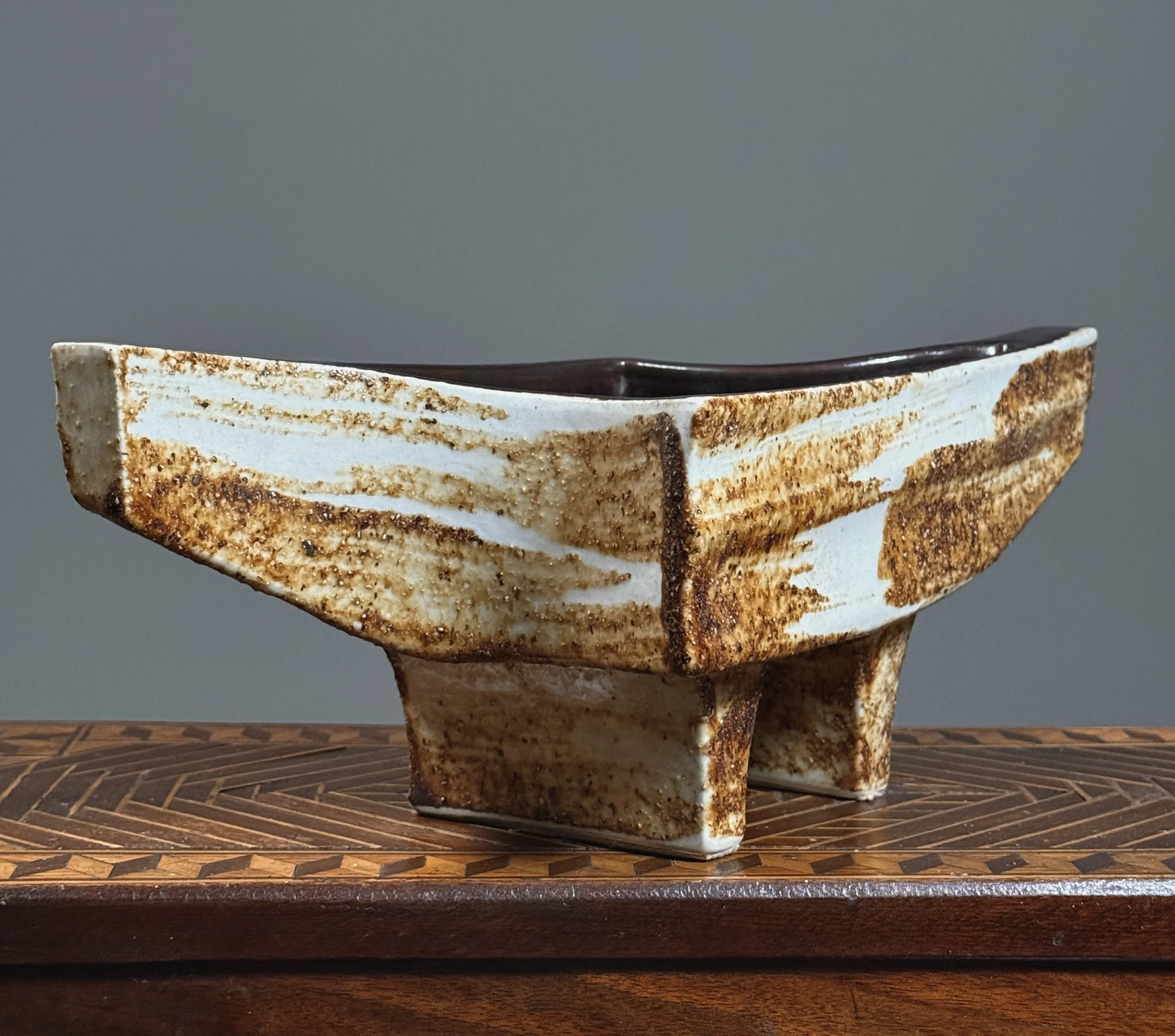 Three-quarter view of a Japanese Brutalist wood-fired ikebana vase.