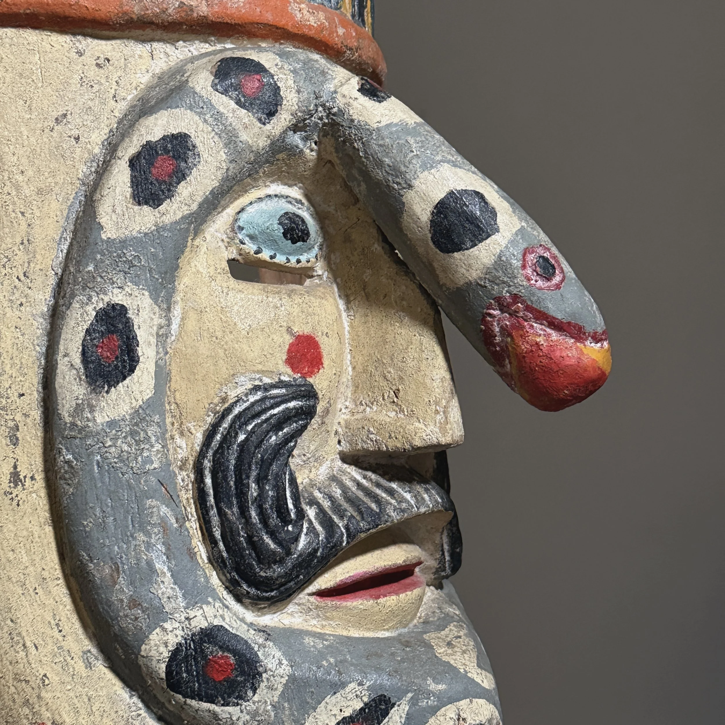 Detail of the eye and cheek area showing paint application.