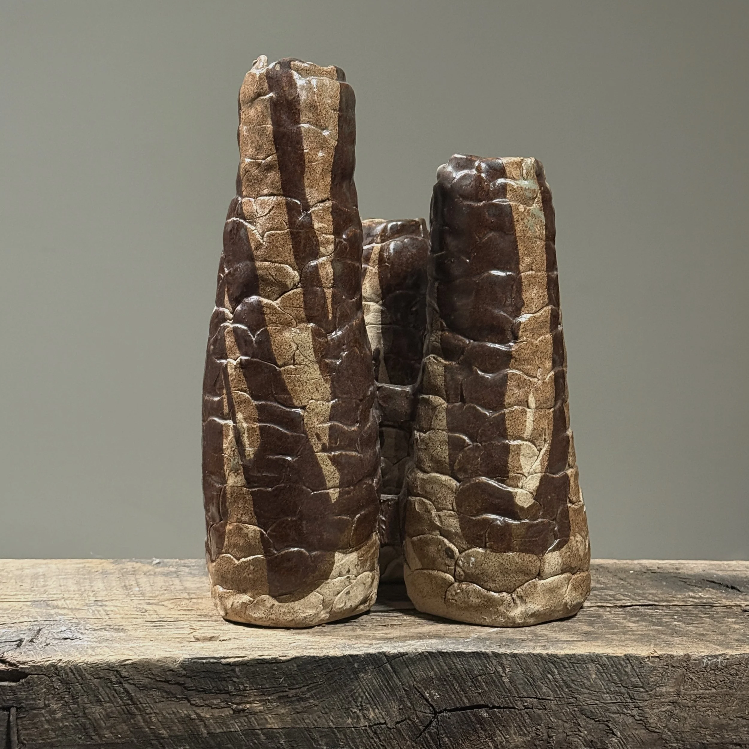 Full frontal view of a vintage Brutalist hand-built ceramic vessel with three connected cylindrical forms