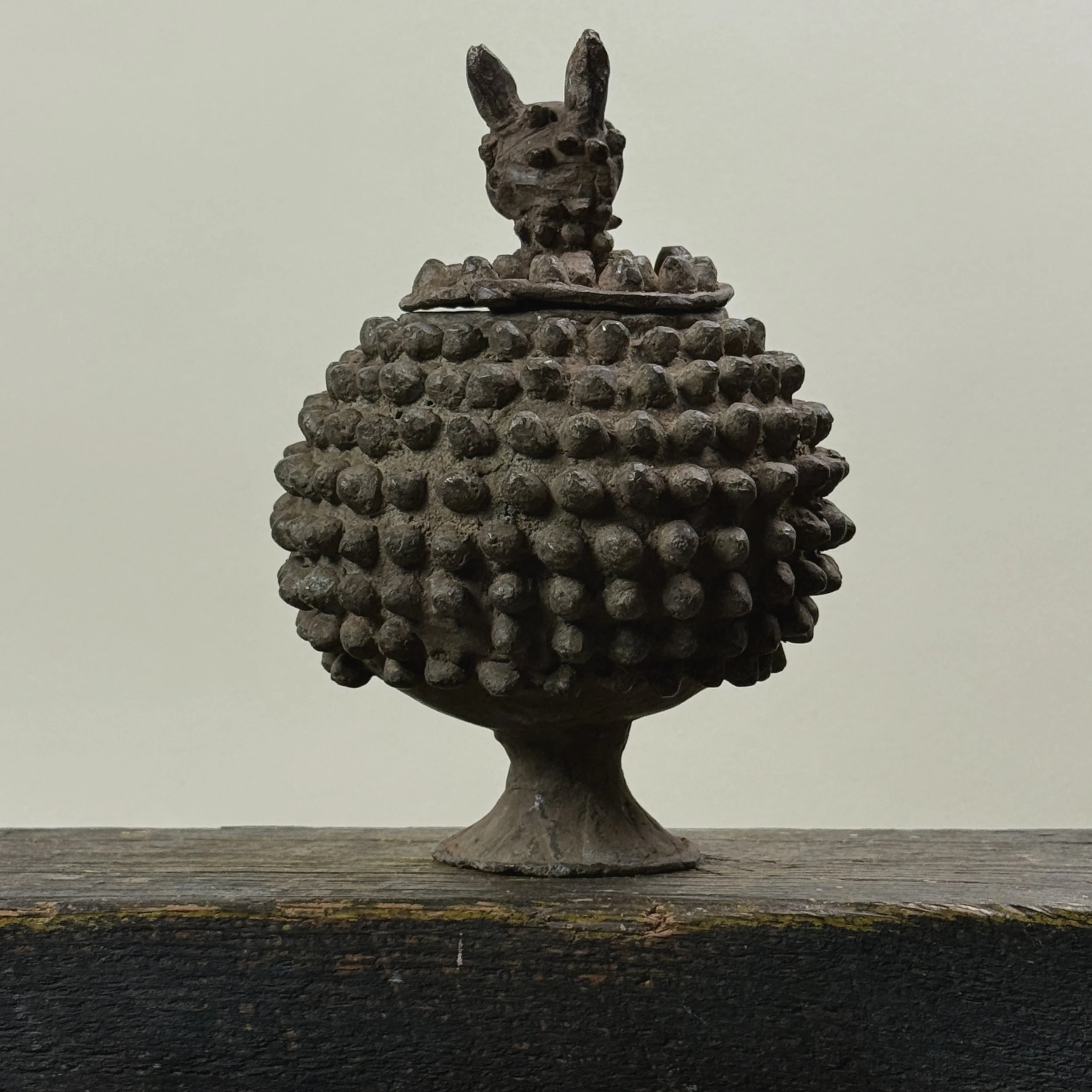 Front view of antique Lobi bronze medicine box with zoomorphic lid