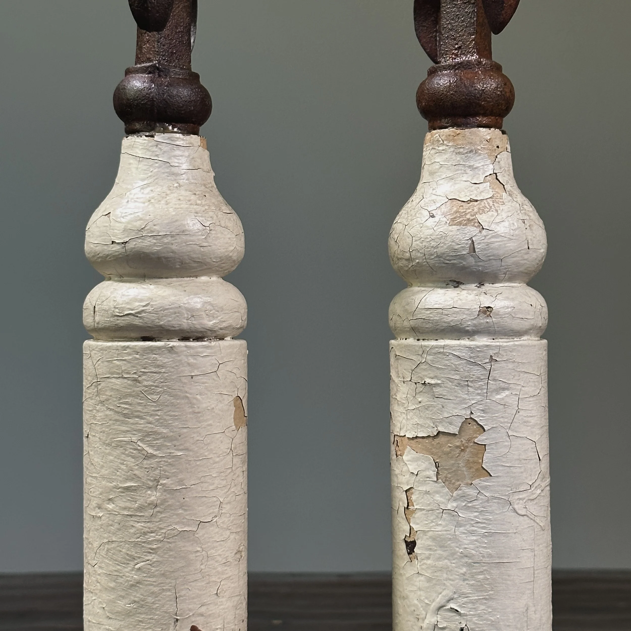 Pair of antique French fleur-de-lis cast iron finials on patinated wood bases