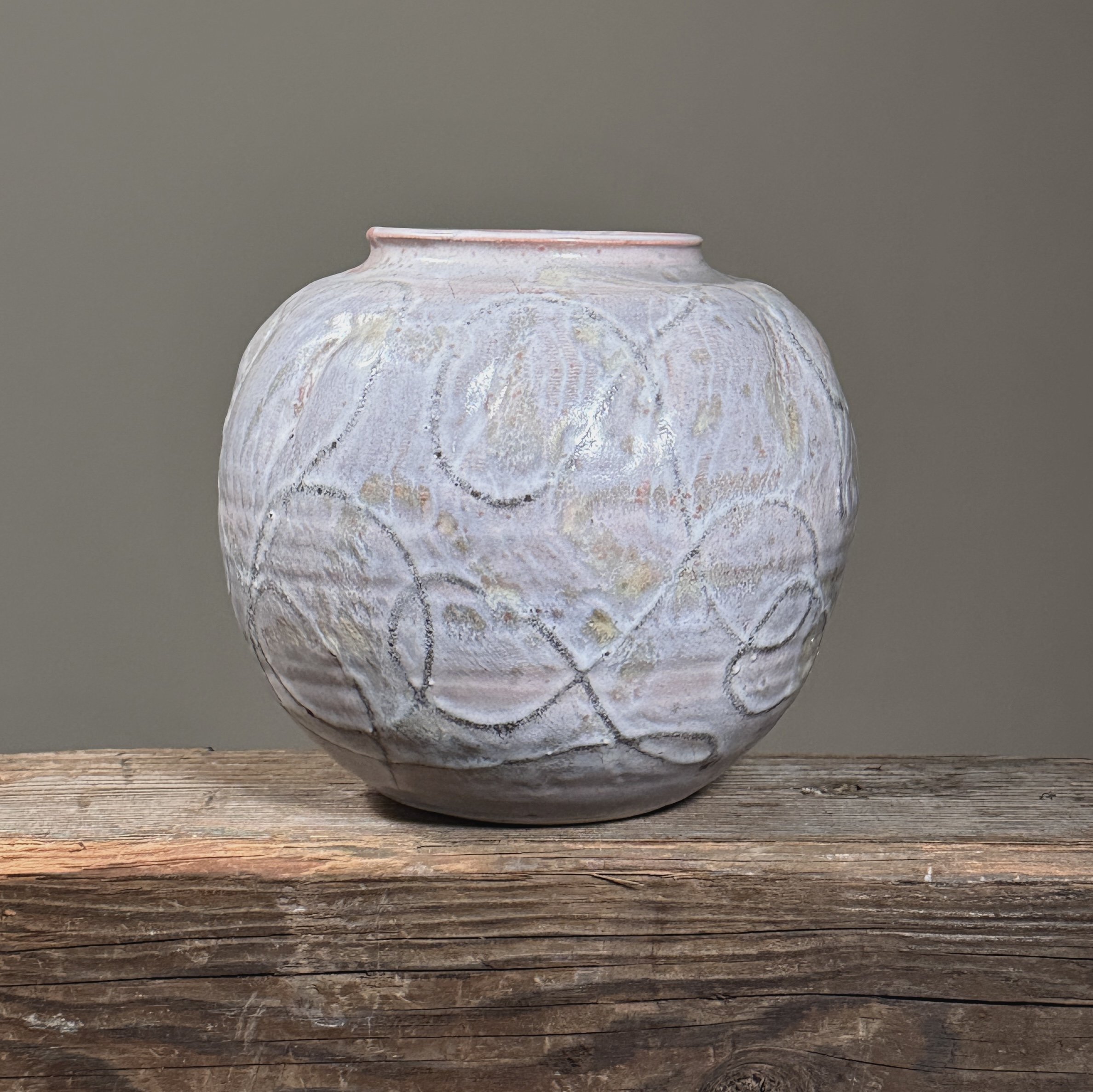 Front view of a vintage Japanese ceramic vase with light purple glaze.