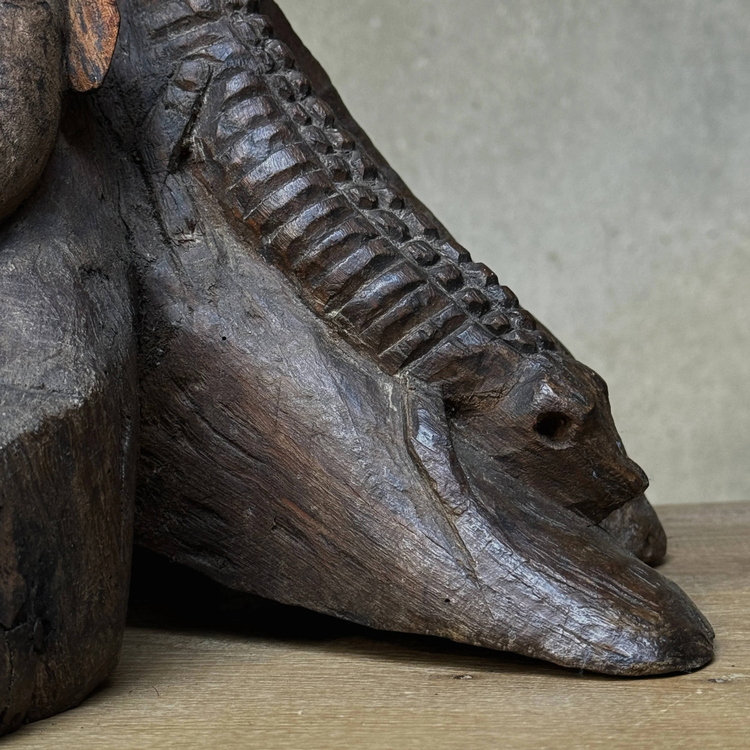 Close-up of reptile motif on folk art carving