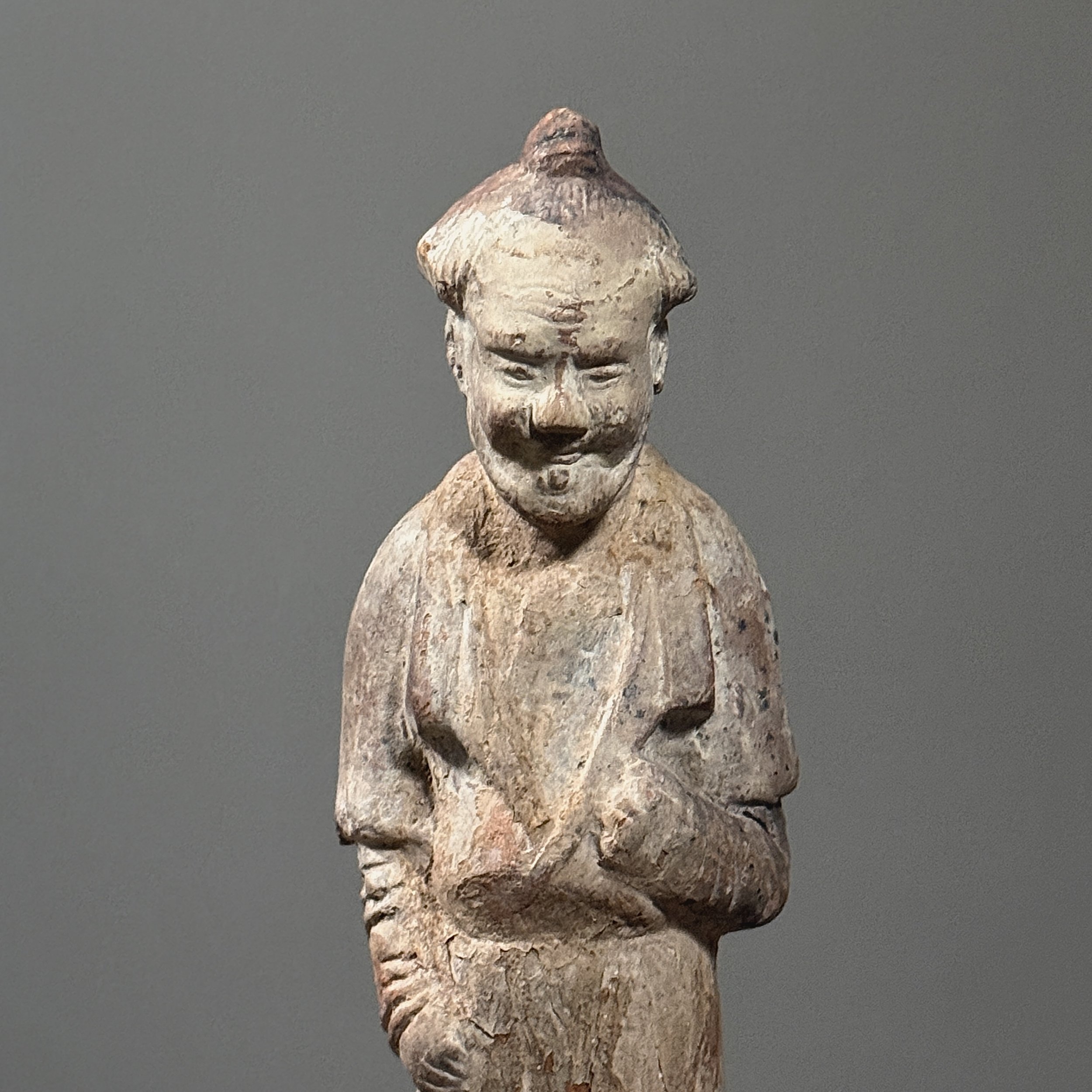 Detailed close-up of the attendant's stylized facial features and headdress.