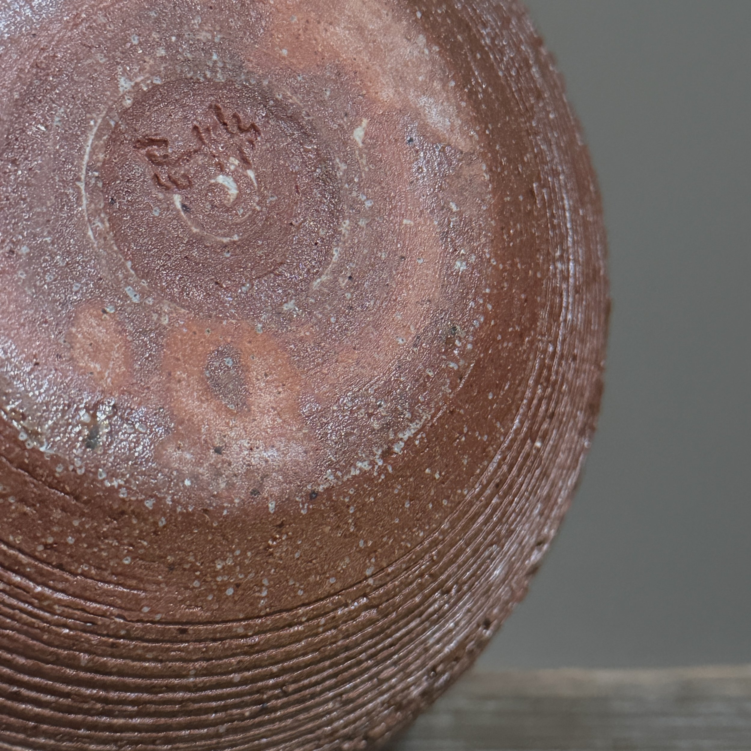 View of the vase's base showing the artist's signature.